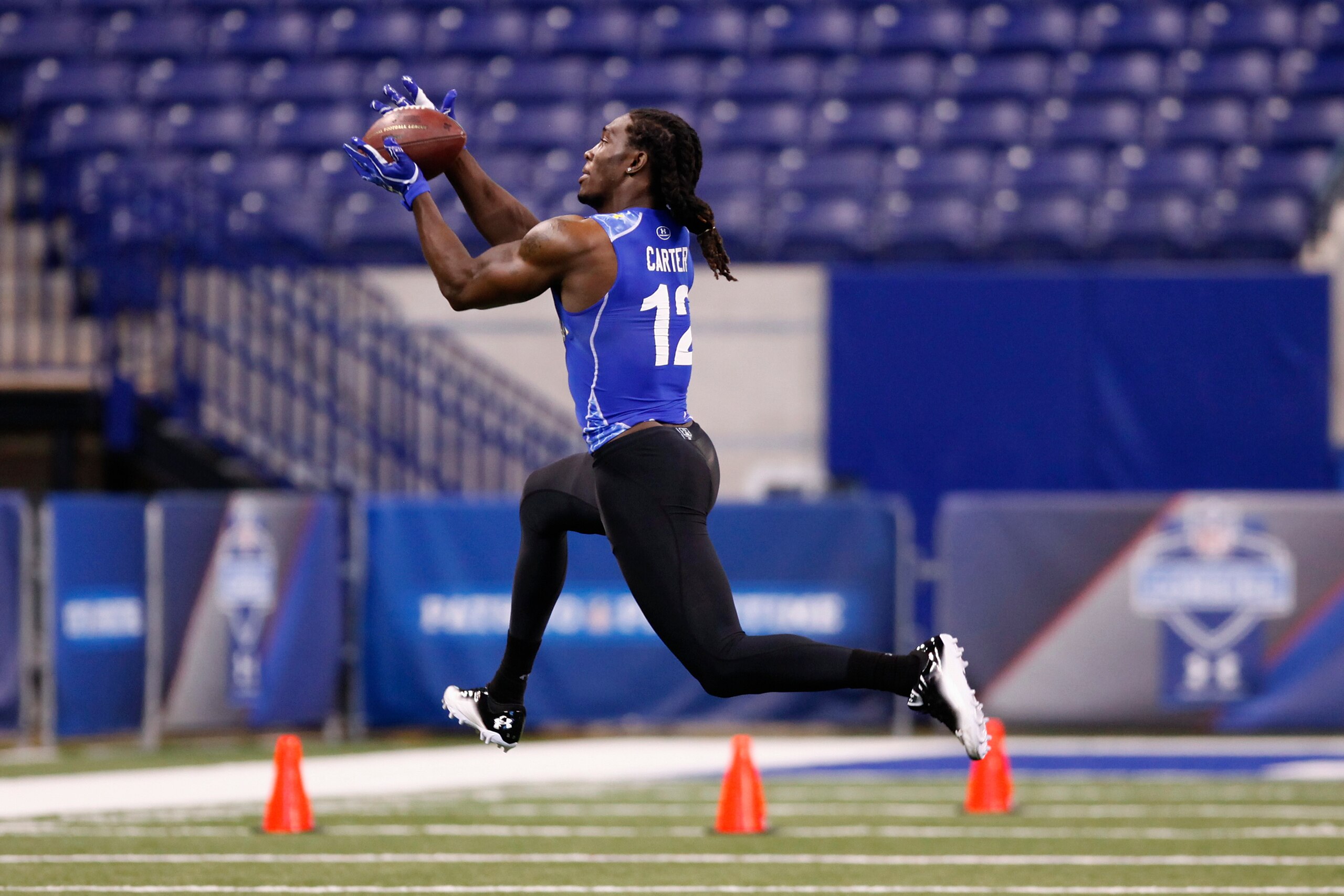 INDIANAPOLIS, IN - MARCH 1: Defensive back Quinton Carter #12 of Oklahoma works out during the 2011 NFL Scouting Combine at Lucas Oil Stadium on February 28, 2011 in Indianapolis, Indiana. (Photo by Joe Robbins/Getty Images)