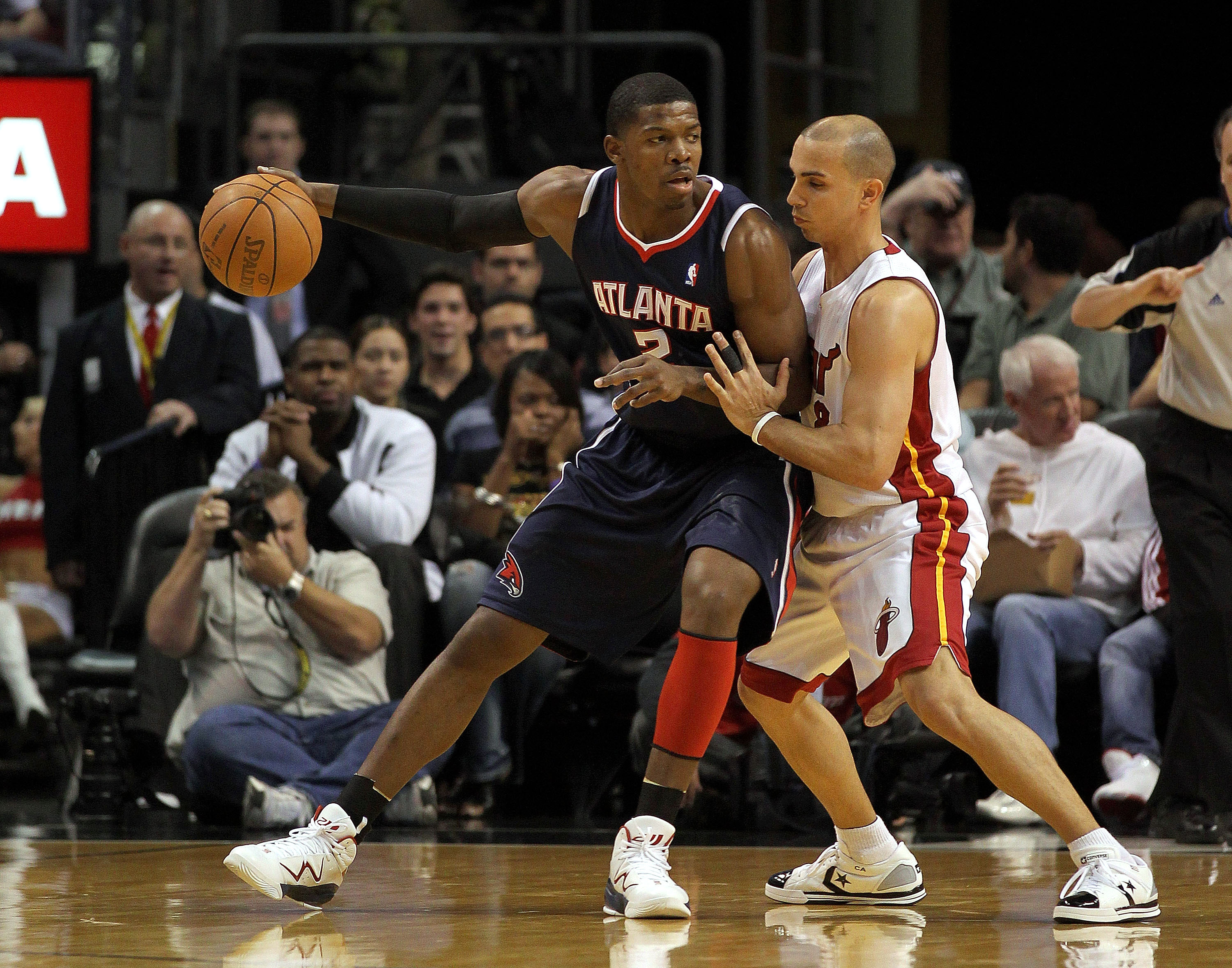 MIAMI, FL - JANUARY 18:  Joe Johnson #2 of the Atlanta Hawks posts up against Carlos Arroyo #8 of the Miami Heat during a game at American Airlines Arena on January 18, 2011 in Miami, Florida. NOTE TO USER: User expressly acknowledges and agrees that, by