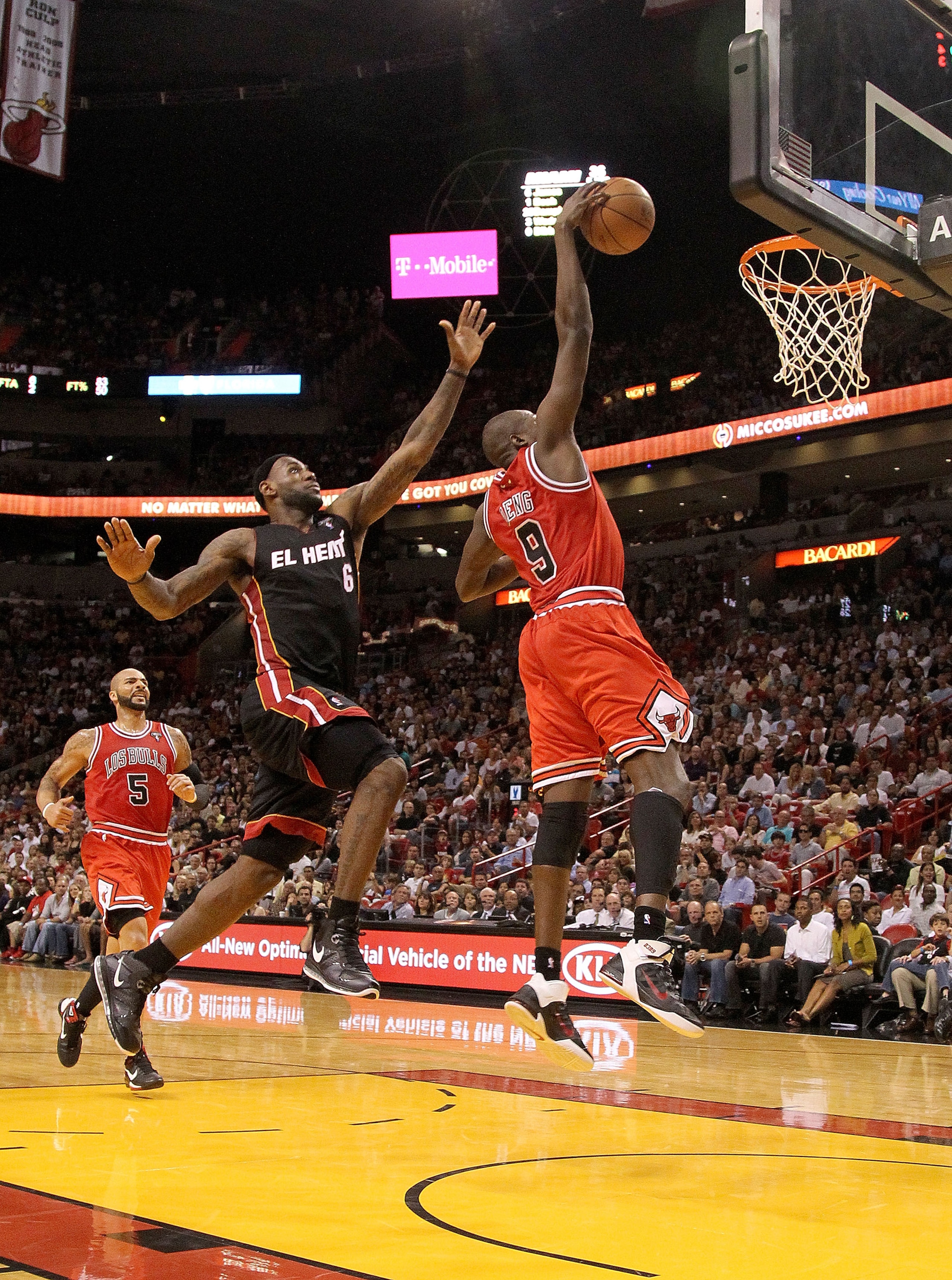 MIAMI, FL - MARCH 06: Luol Deng #9 of the Chicago Bulls dunks past LeBron James #6 of the Miami Heat during a game at American Airlines Arena on March 6, 2011 in Miami, Florida. NOTE TO USER: User expressly acknowledges and agrees that, by downloading an MIAMI, FL - MARCH 06: Luol Deng #9 of the Chicago Bulls dunks past LeBron James #6 of the Miami Heat during a game at American Airlines Arena on March 6, 2011 in Miami, Florida. NOTE TO USER: User expressly acknowledges and agrees that, by downloading an