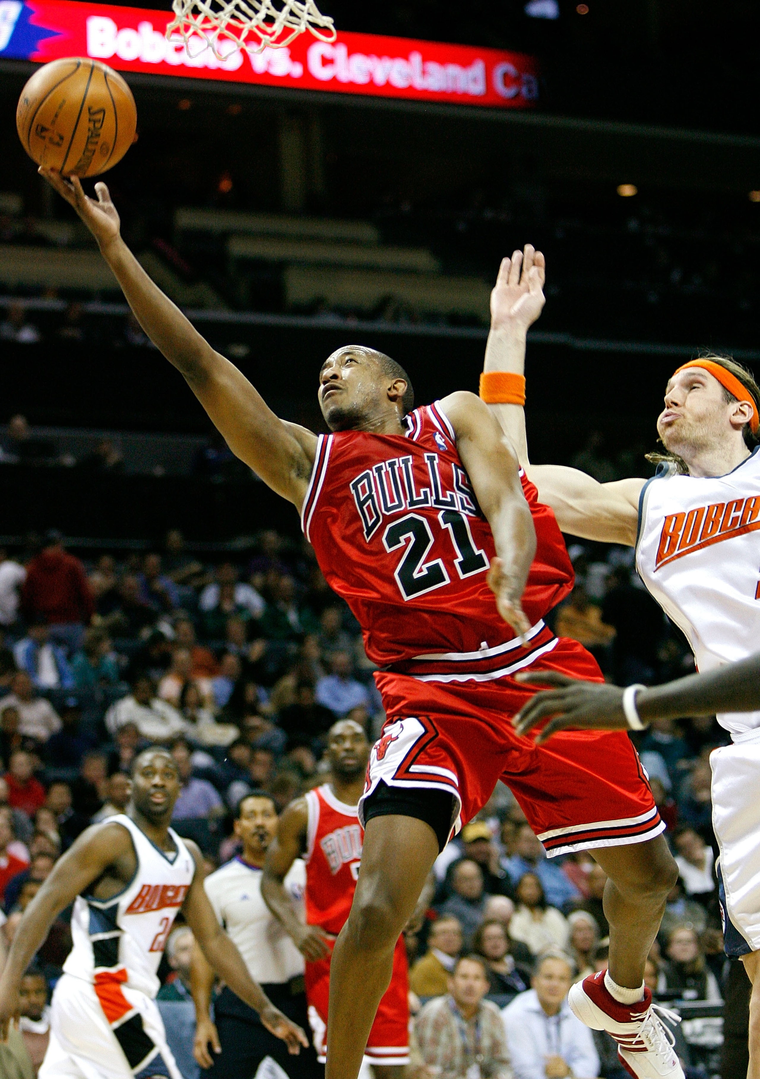 CHARLOTTE, NC - DECEMBER 05: Chris Duhon #21 of the Chicago Bulls lays in a basket past Walter Herrmann #5 of the Charlotte Bobcats during the second half at Bobcats Arena on December 5, 2007 in Charlotte, North Carolina. Chicago defeated Charlotte 91-8 CHARLOTTE, NC - DECEMBER 05: Chris Duhon #21 of the Chicago Bulls lays in a basket past Walter Herrmann #5 of the Charlotte Bobcats during the second half at Bobcats Arena on December 5, 2007 in Charlotte, North Carolina. Chicago defeated Charlotte 91-8