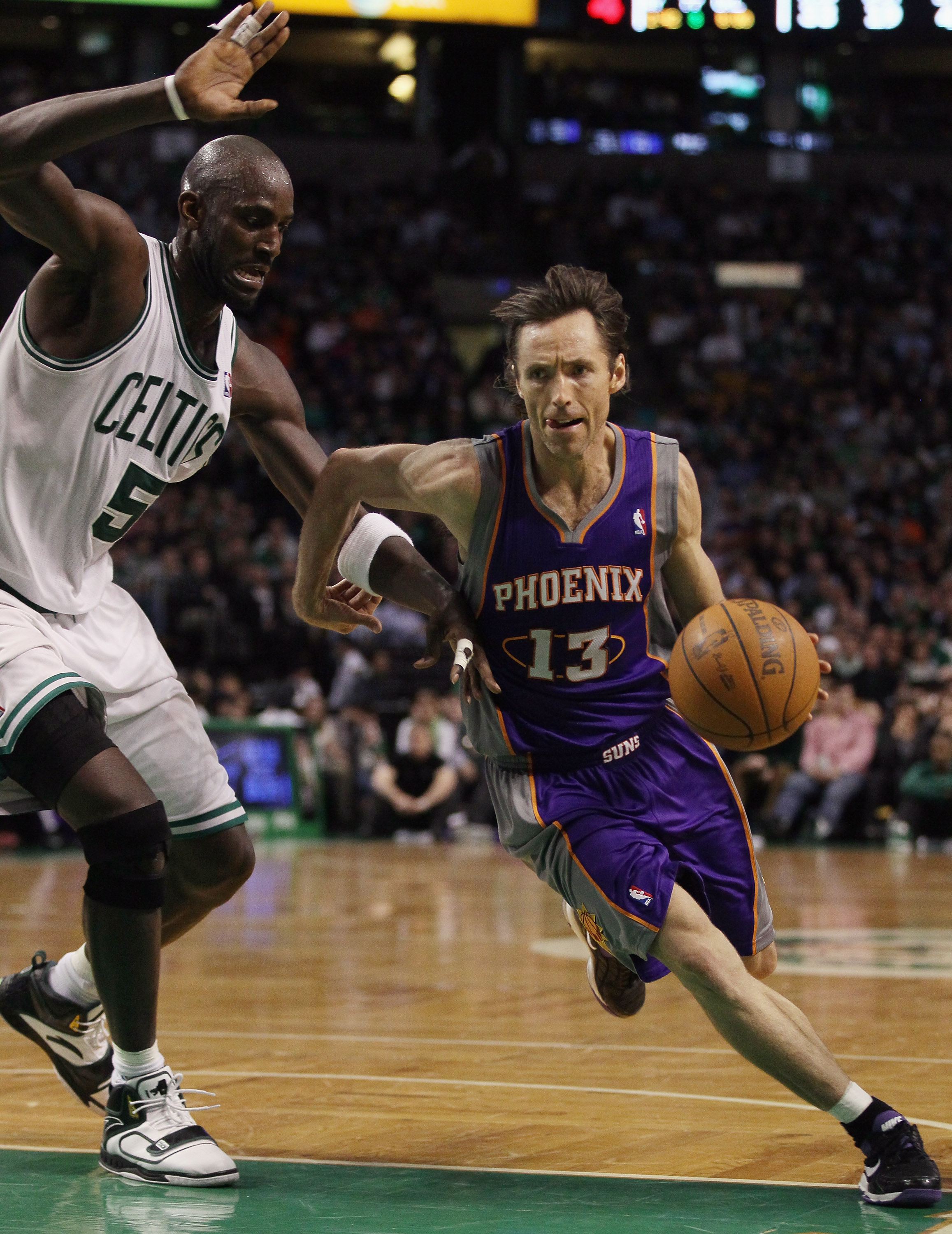 BOSTON, MA - MARCH 02:  Steve Nash #13 of the Phoenix Suns drives around Kevin Garnett #5 of the Boston Celtics on March 2, 2011 at the TD Garden in Boston, Massachusetts.  The Celtics defeated the Suns 115-103. NOTE TO USER: User expressly acknowledges a