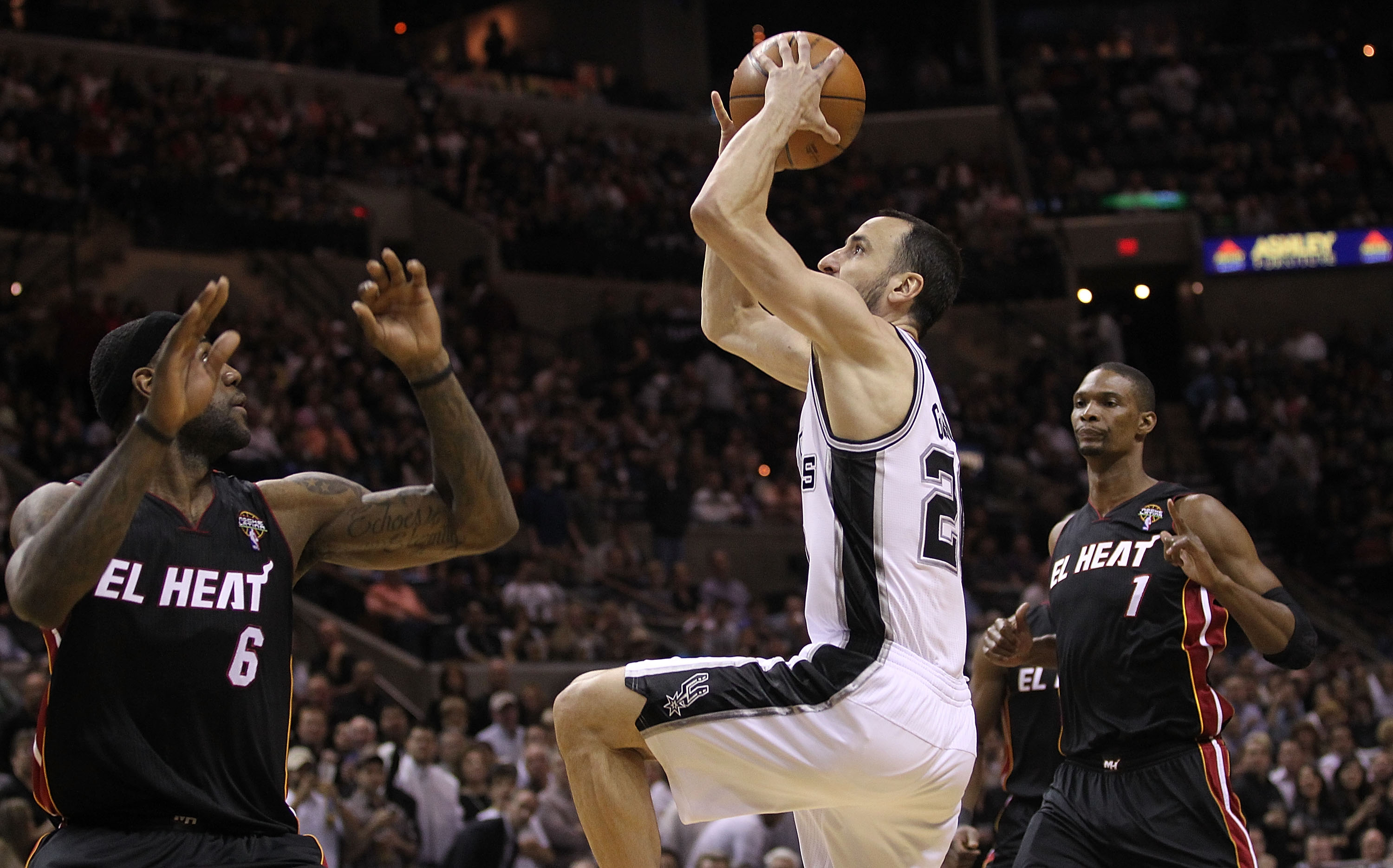 SAN ANTONIO, TX - MARCH 04:  Guard Manu Ginobili #20 of the San Antonio Spurs takes a shot against LeBron James #6 of the Miami Heat at AT&T Center on March 4, 2011 in San Antonio, Texas.   NOTE TO USER: User expressly acknowledges and agrees that, by dow