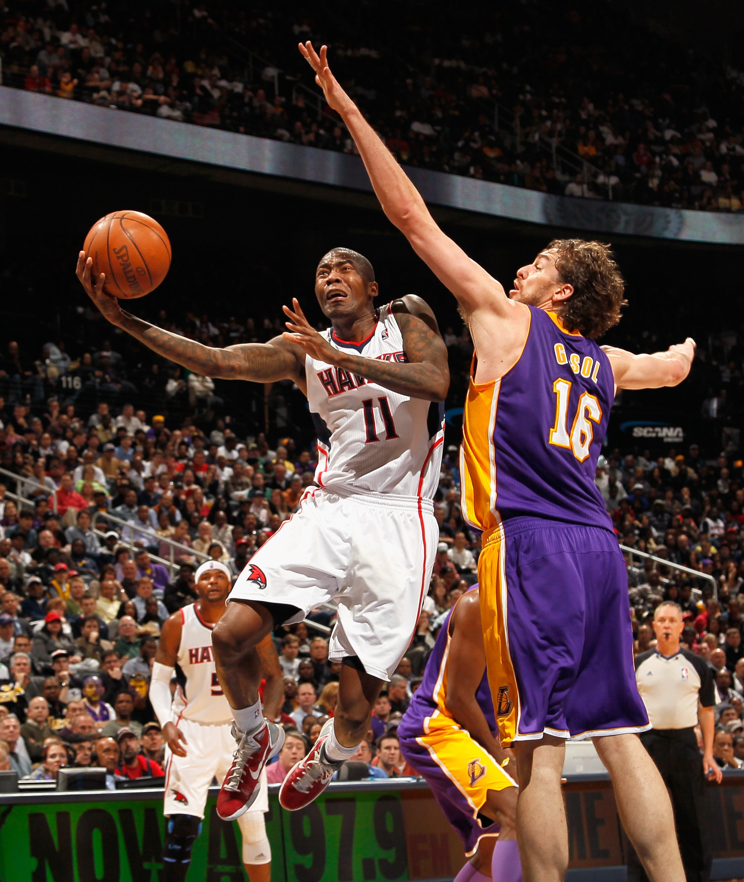 ATLANTA, GA - MARCH 08:  Pau Gasol #16 of the Los Angeles Lakers defends against Jamal Crawford #11 of the Atlanta Hawks at Philips Arena on March 8, 2011 in Atlanta, Georgia.  NOTE TO USER: User expressly acknowledges and agrees that, by downloading and/