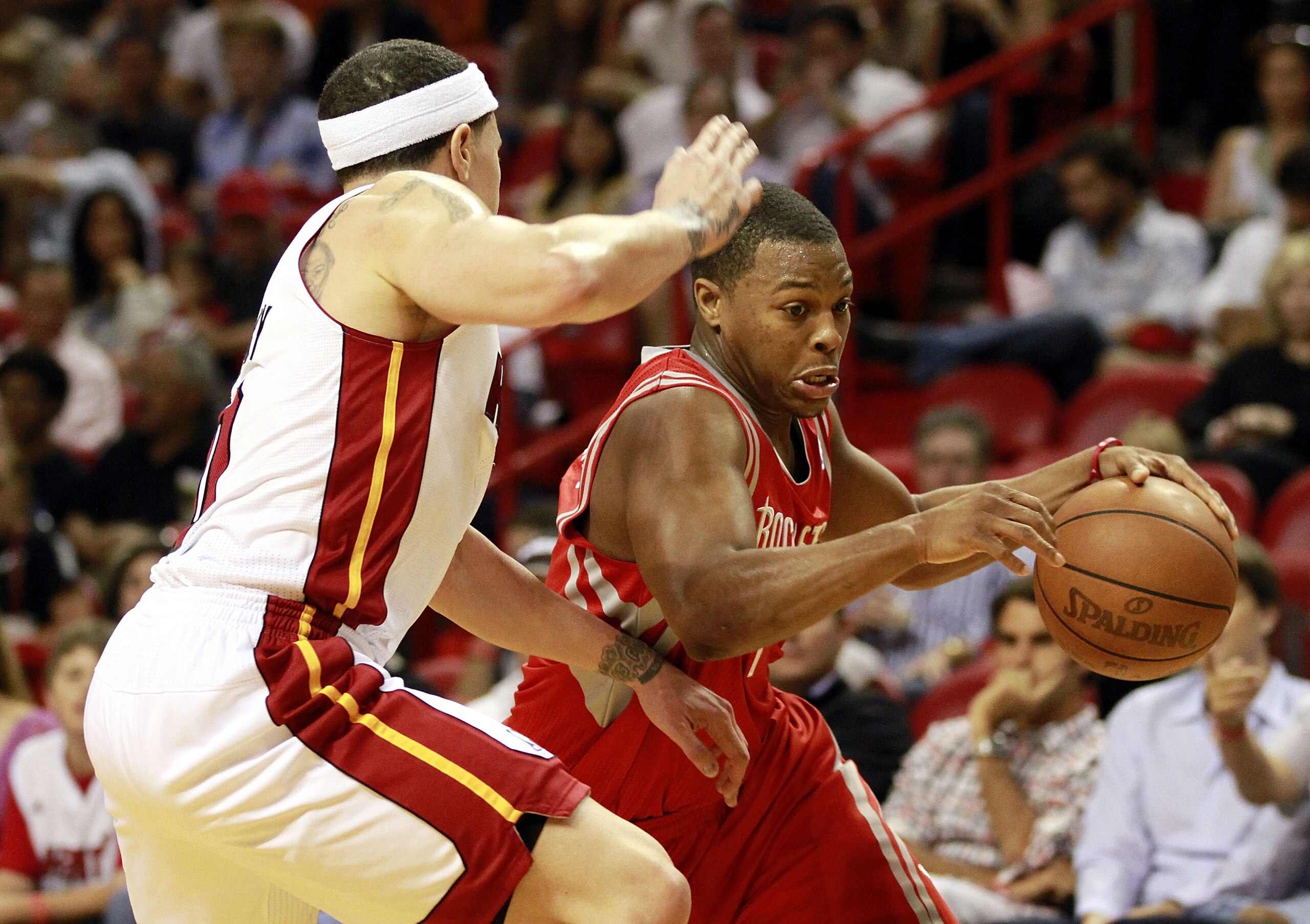 MIAMI, FL - MARCH 27:  Guard Mike Bibby #0 of the Miami Heat defends against gurad Kyle Lowry #7 of the Houston Rockets  at American Airlines Arena on March 27, 2011 in Miami, Florida. NOTE TO USER: User expressly acknowledges and agrees that, by download