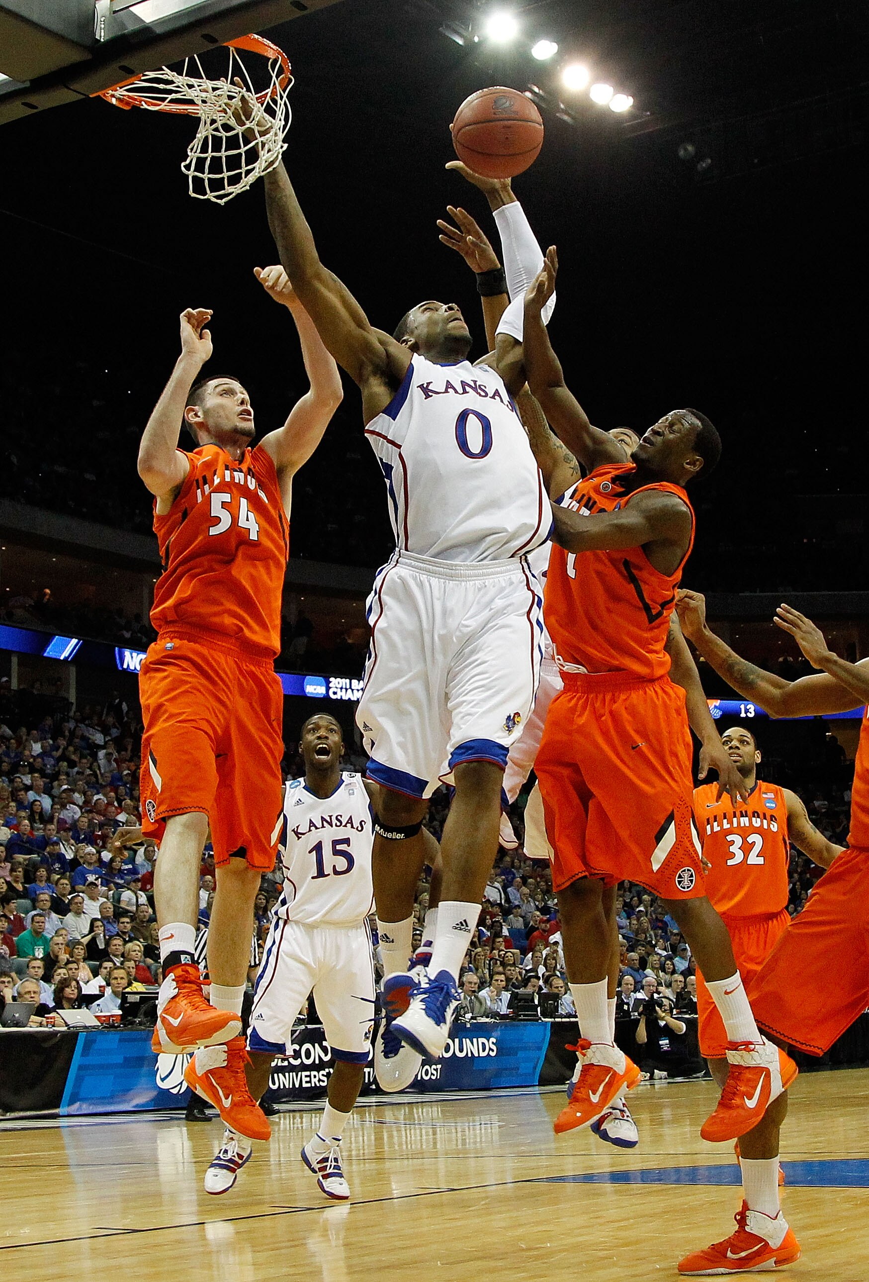 TULSA, OK - MARCH 20:  Thomas Robinson #0 of the Kansas Jayhawks goes up for a shot against Mike Tisdale #54 and D.J. Richardson #1 of the Illinois Fighting Illini during the third round of the 2011 NCAA men's basketball tournament at BOK Center on March 