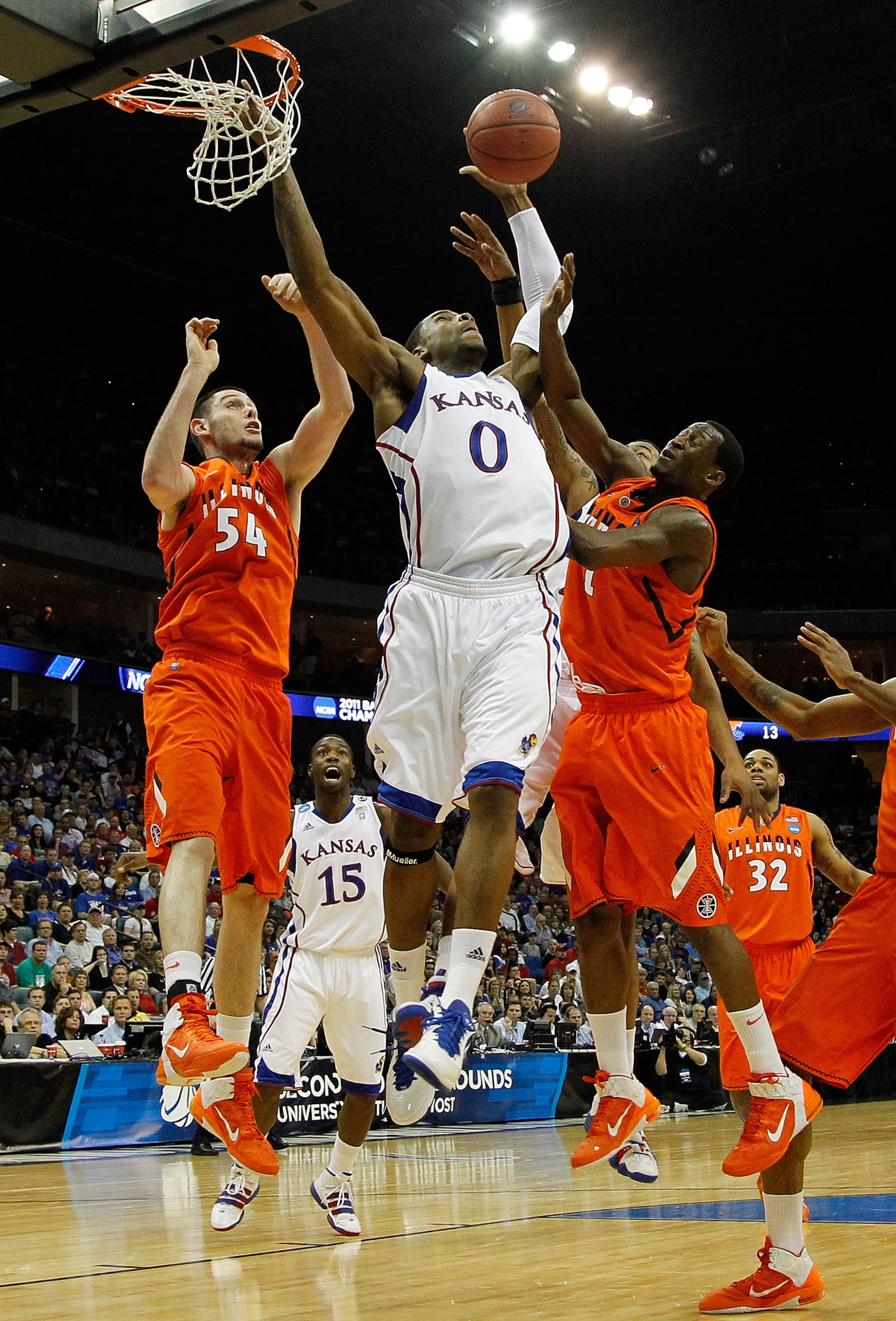 TULSA, OK - MARCH 20:  Thomas Robinson #0 of the Kansas Jayhawks goes up for a shot against Mike Tisdale #54 and D.J. Richardson #1 of the Illinois Fighting Illini during the third round of the 2011 NCAA men's basketball tournament at BOK Center on March 