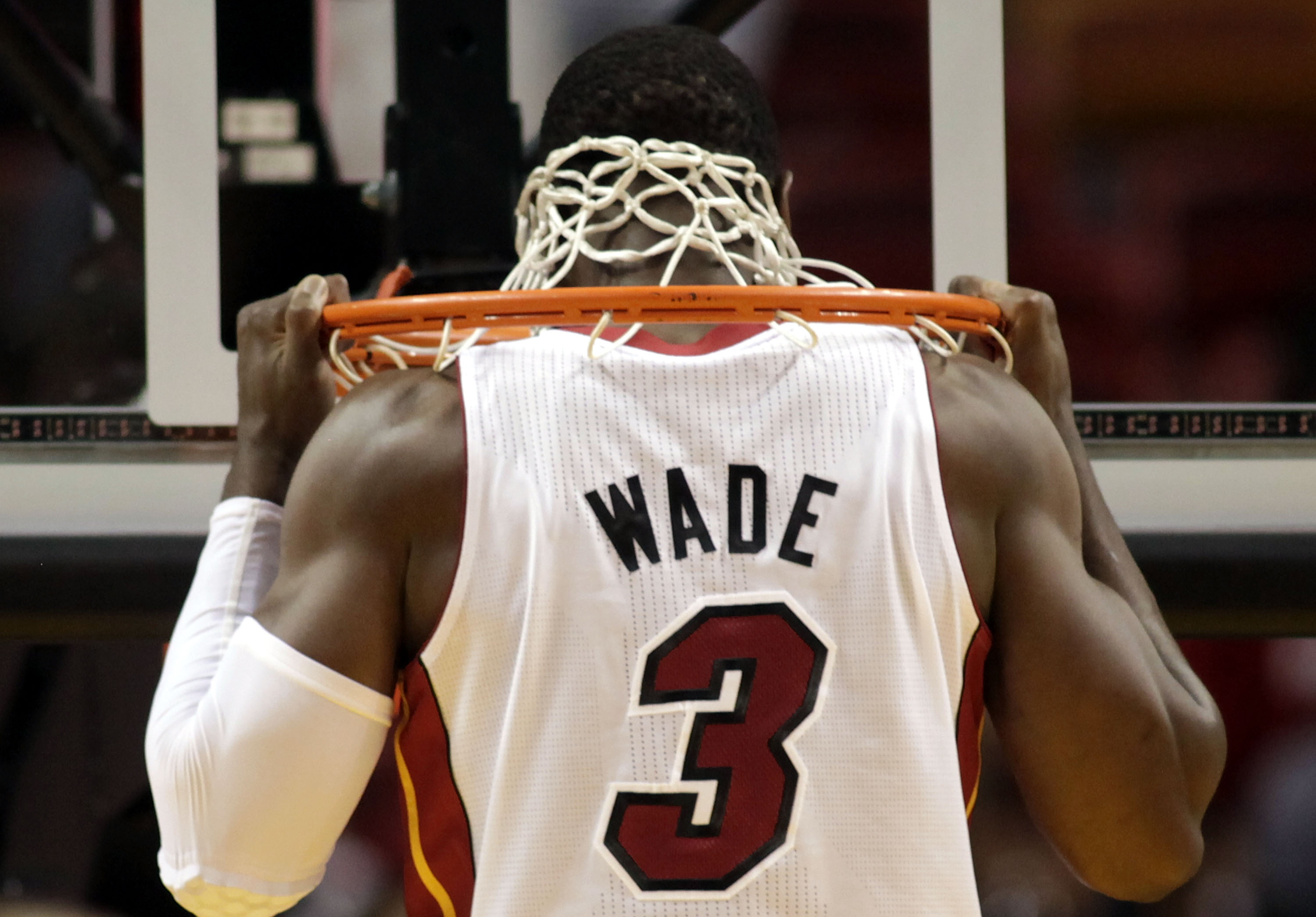 MIAMI, FL - MARCH 27:  Guard Dwyane Wade of the Miami Heat stretches against the Houston Rockets at American Airlines Arena on March 27, 2011 in Miami, Florida. NOTE TO USER: User expressly acknowledges and agrees that, by downloading and/or using this Ph