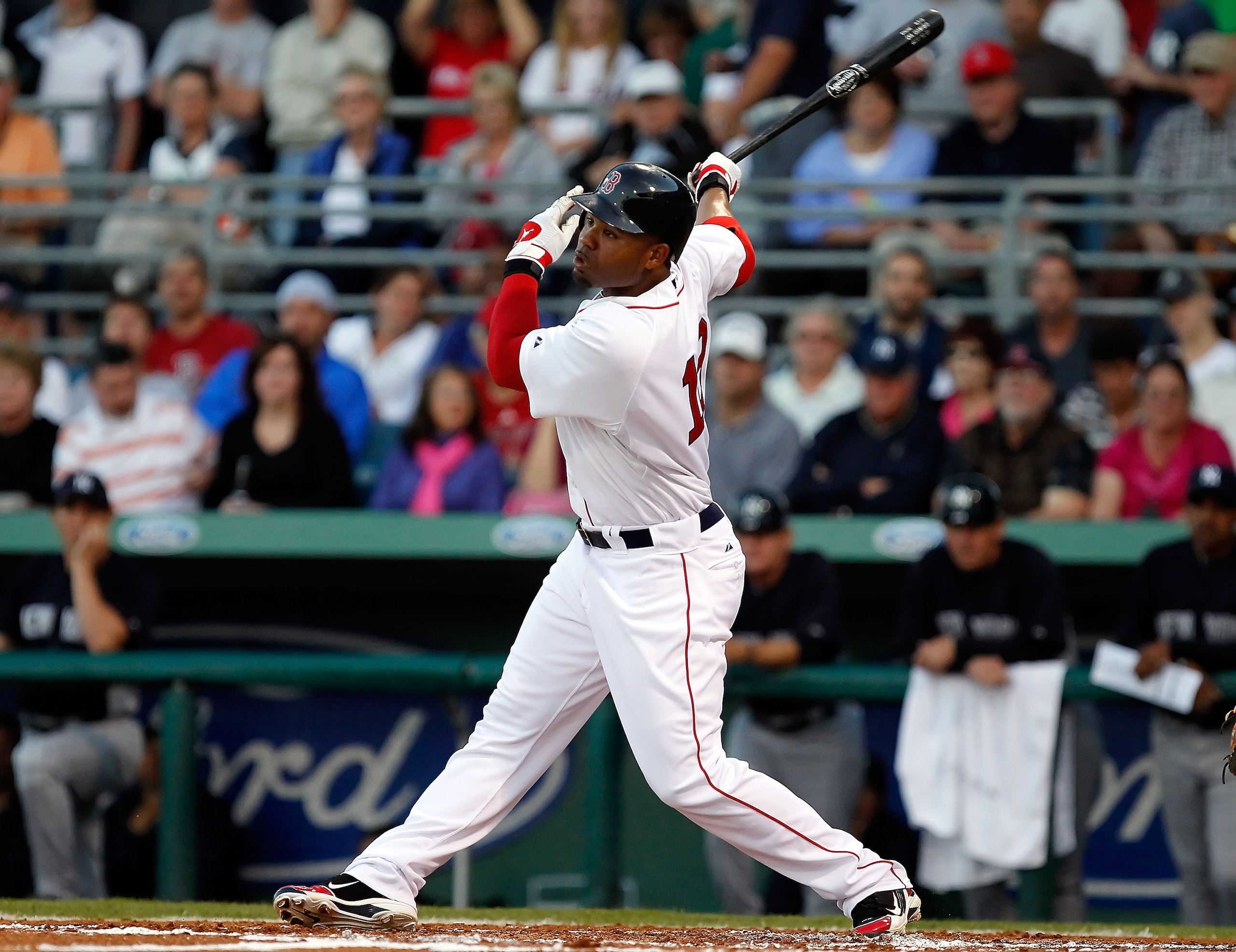 FORT MYERS, FL - MARCH 14:  Outfielder Carl Crawford #13 of the Boston Red Sox fouls off a pitch against the New York Yankees during a Grapefruit League Spring Training Game at City of Palms Park on March 14, 2011 in Fort Myers, Florida.  (Photo by J. Mer