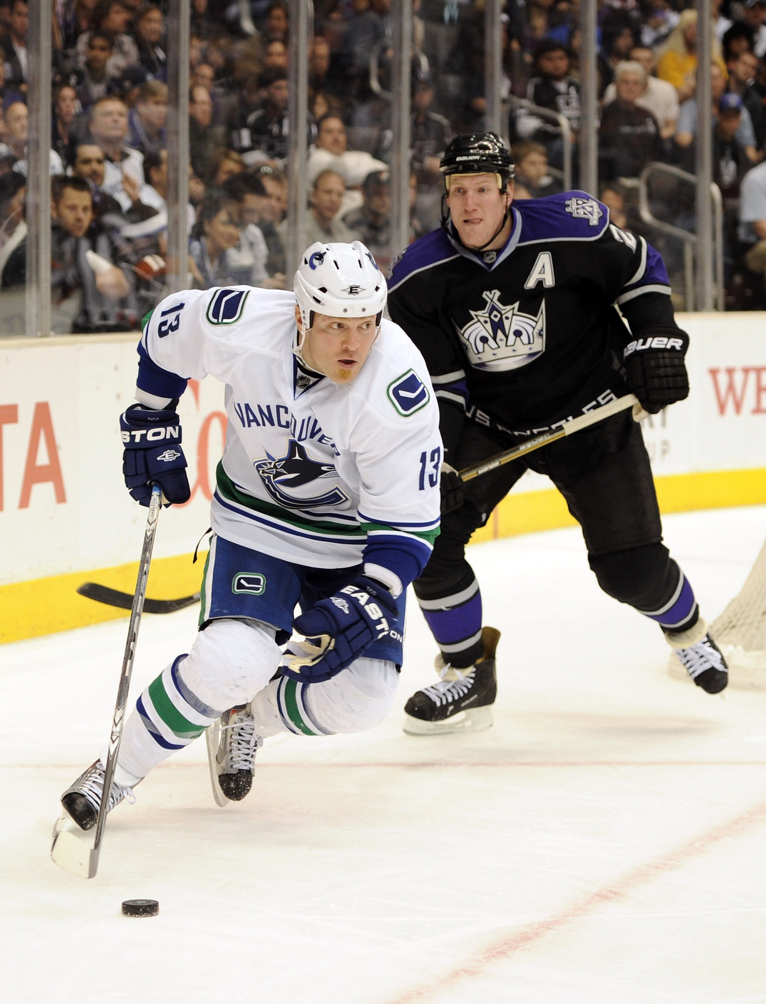 LOS ANGELES, CA - MARCH 05:  Raffi Torres #13 of the Vancouver Canucks looks to make a pass in front of Matt Greene #2 of the Los Angeles Kings at the Staples Center on March 5, 2011 in Los Angeles, California.  (Photo by Harry How/Getty Images)