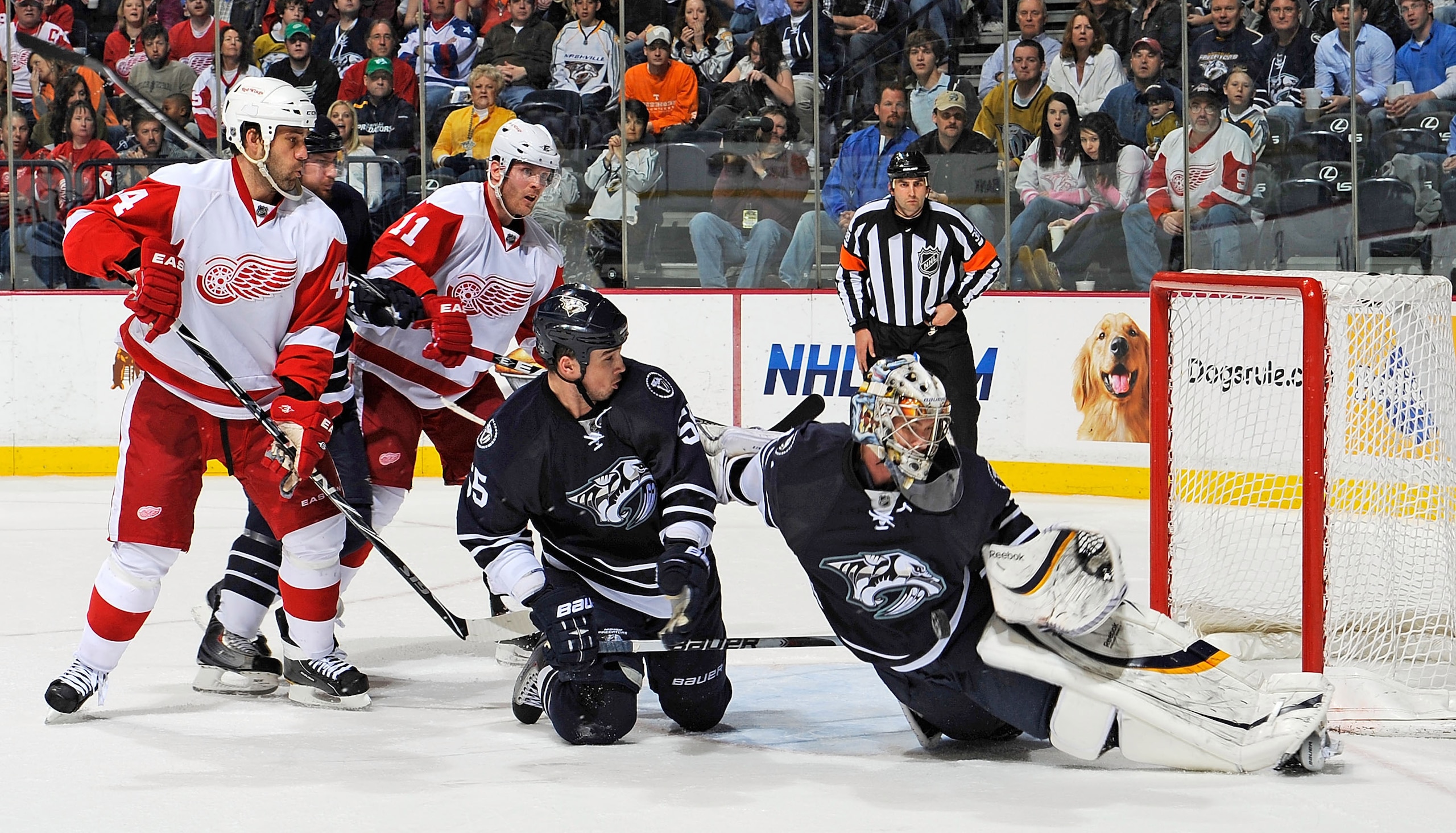 NASHVILLE, TN - MARCH 19:  Shane O'Brien #55 slides in front of Todd Bertuzzi #44 and Danny Cleary #11 of the Detroit Red Wings as Predators goalie Pekka Rinne #35 makes a save on March 19, 2011 at the Bridgestone Arena in Nashville, Tennessee.  (Photo by