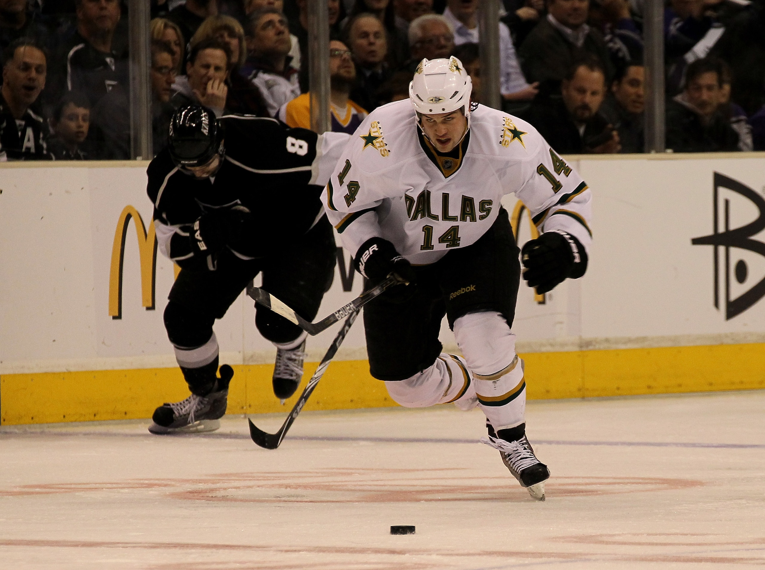 LOS ANGELES, CA - MARCH 07:  Jamie Benn #14 of the Dallas Stars breaks away with the puck in front of  Drew Doughty #8 of the Los Angeles Kings on his way to scoring a shorthanded goal in the third period at Staples Center on March 7, 2011 in Los Angeles,