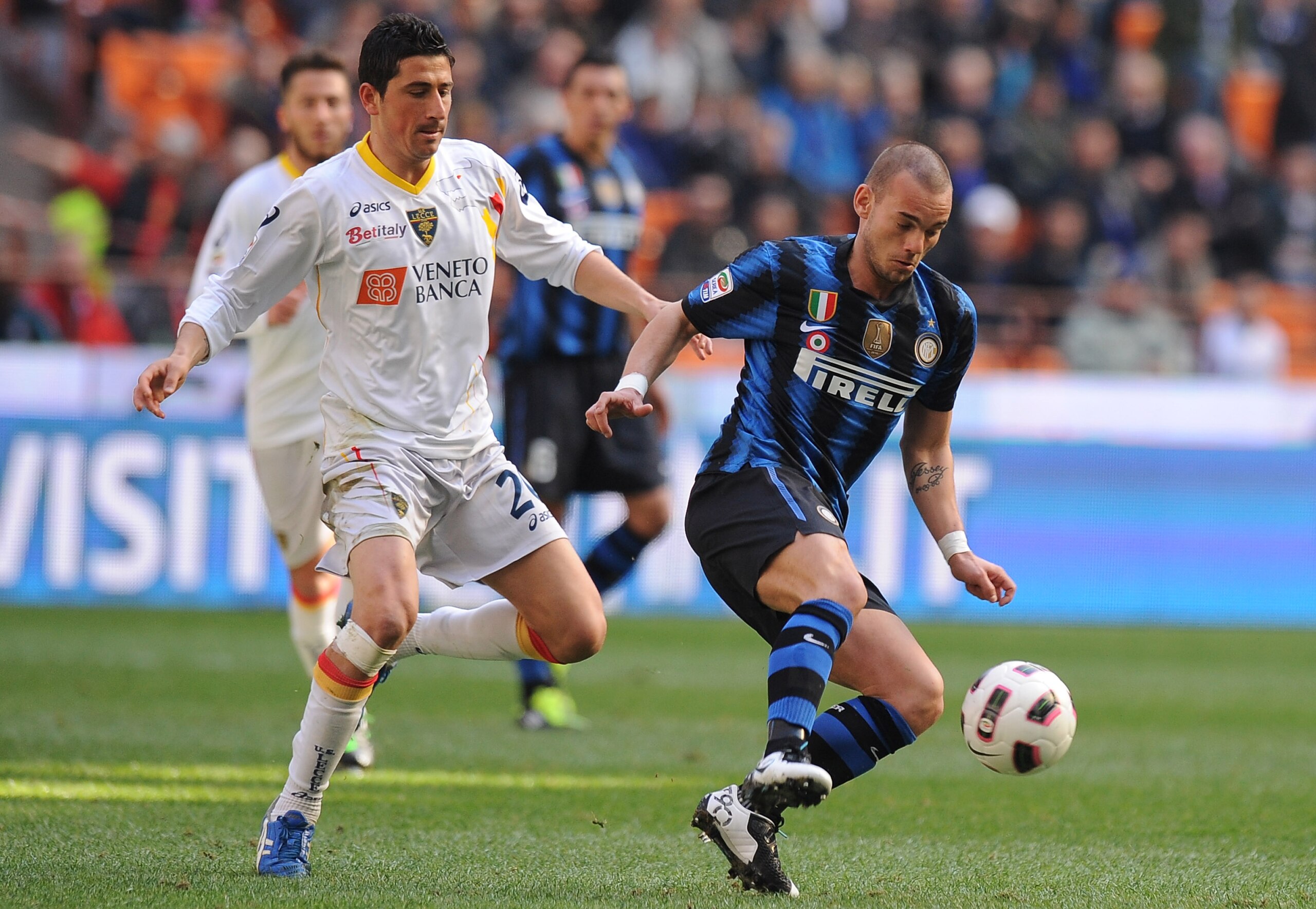 MILAN, ITALY - MARCH 20:  Wesley Sneijder (R) of Inter Milan holds off the challenge from Giuseppe Vives of Lecce during the Serie A match between FC Intern Milan and Lecce at Stadio Giuseppe Meazza on March 20, 2011 in Milan, Italy.  (Photo by Tullio M.