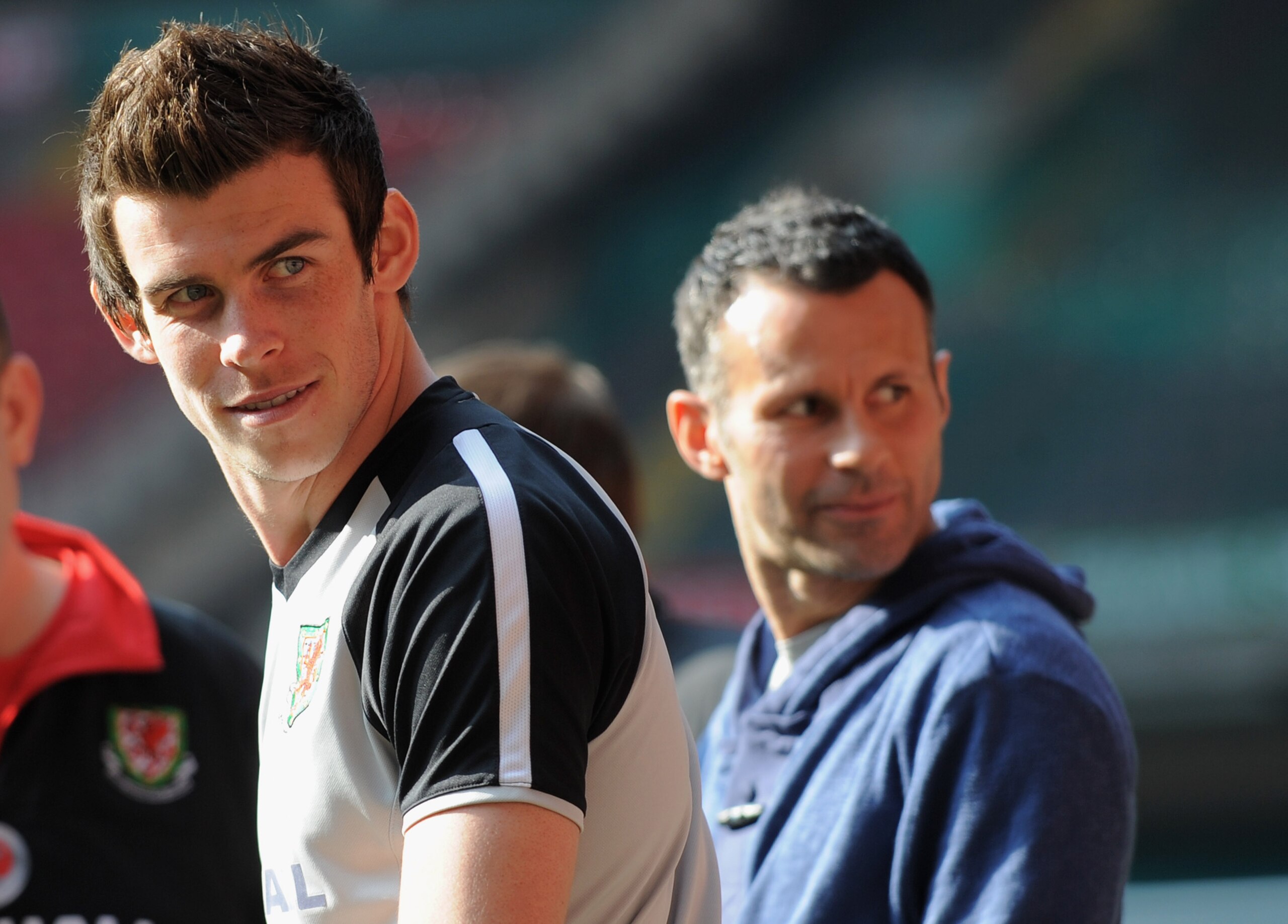 CARDIFF, WALES - MARCH 25:  Gareth Bale looks on as he sits out with an injury with Ryan Giggs during the Wales training session ahead of their UEFA EURO 2012 qualifier against England on March 25, 2011 in Cardiff, Wales.  (Photo by Michael Regan/Getty Im
