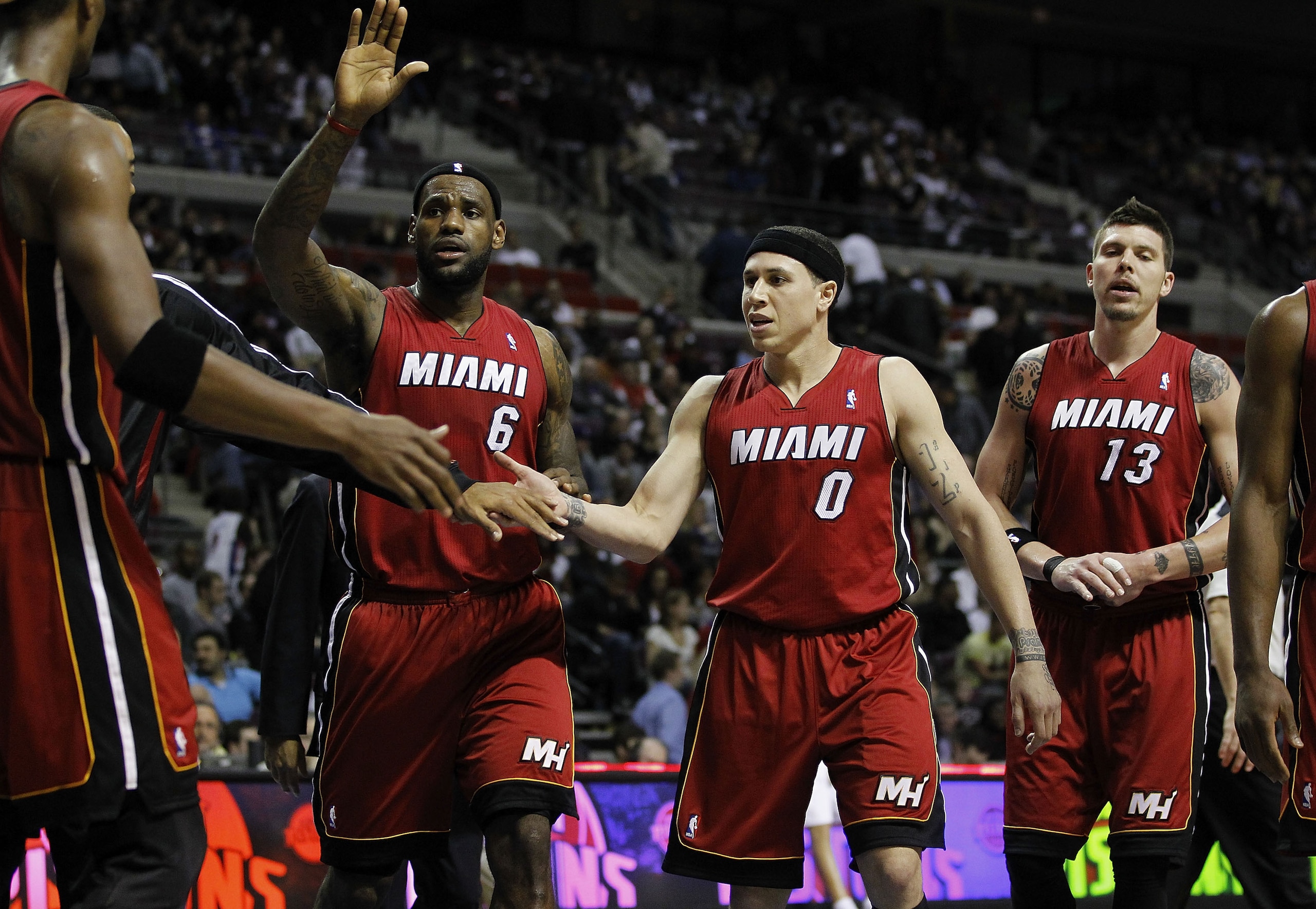 AUBURN HILLS, MI - MARCH 23:  LeBron James #6, Mike Bibby #0 and Mike Miller #13 of the Miami Heat celebrate at the end of the first half while playing the Detroit Pistons at The Palace of Auburn Hills on March 23, 2011 in Auburn Hills, Michigan. Miami wo