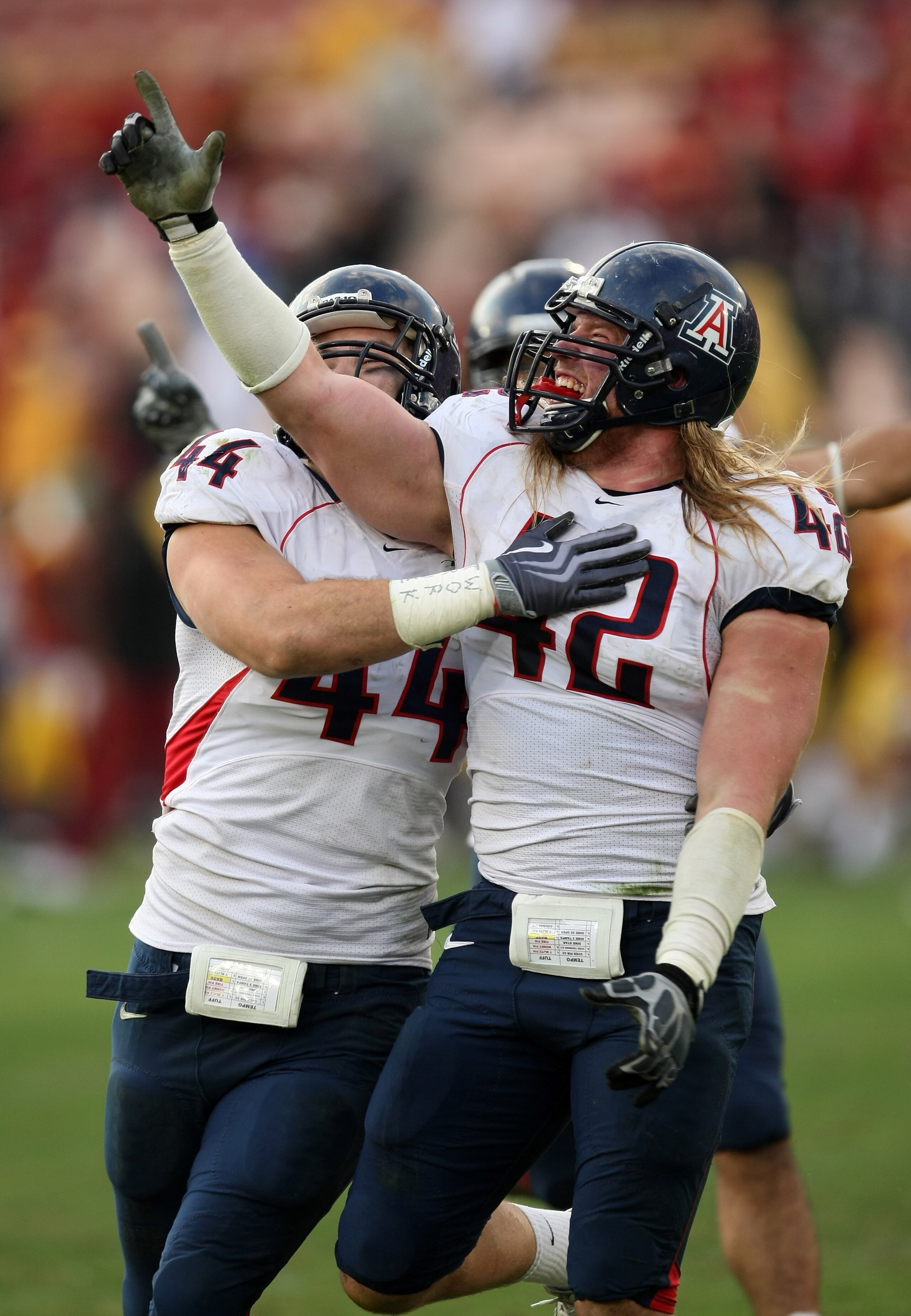 LOS ANGELES, CA - DECEMBER 05:  Defensive ends Brooks Reed #42 and Ricky Elmore #44 of the Arizona Wildcats celebrate after stopping the USC Trojans on the final play on December 5, 2009 at the Los Angeles Coliseum in Los Angeles, California. Arizona won 