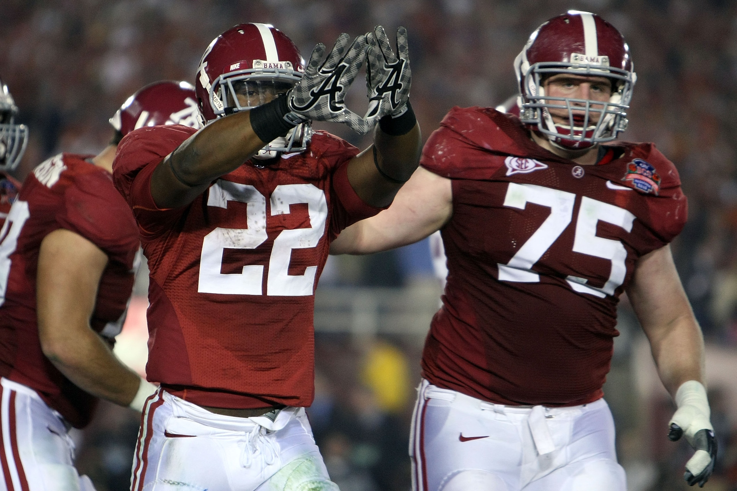 PASADENA, CA - JANUARY 07:  Running back Mark Ingram #22 and lineman Barrett Jones #75 of the Alabama Crimson Tide celebrate a touchdown against the Texas Longhorns in the second quarter of the Citi BCS National Championship game at the Rose Bowl on Janua