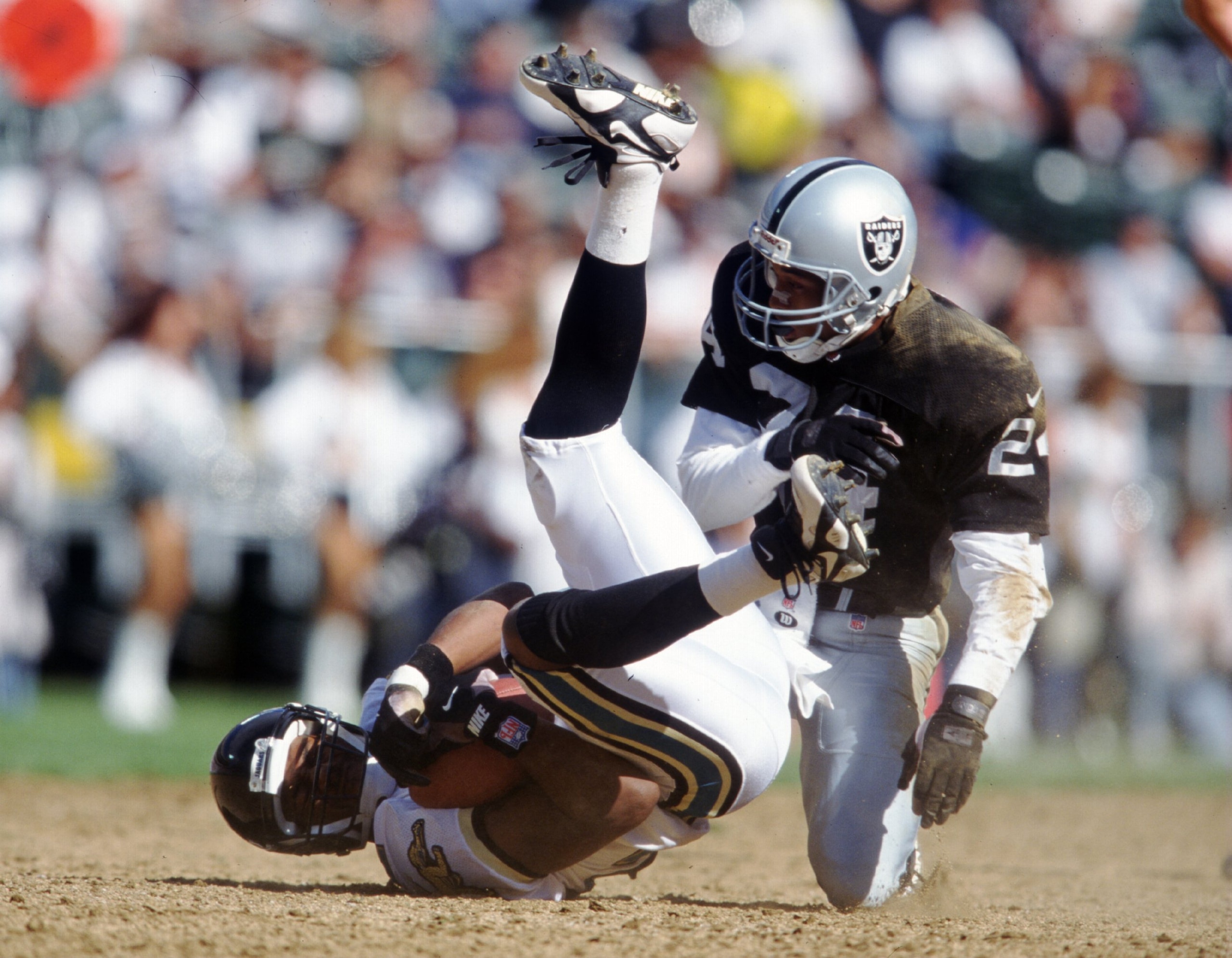 15 Sep 1996: Defensive back Larry Brown #24 of the Oakland Raiders puts a hit on receiver Jimmy Smith of the Jacksonville Jaguars during the Raiders 17-3 win at the Oakland Coliseum in Oakland, California. Mandatory Credit: Stephen Dunn/ALLSPORT 15 Sep 1996: Defensive back Larry Brown #24 of the Oakland Raiders puts a hit on receiver Jimmy Smith of the Jacksonville Jaguars during the Raiders 17-3 win at the Oakland Coliseum in Oakland, California. Mandatory Credit: Stephen Dunn/ALLSPORT