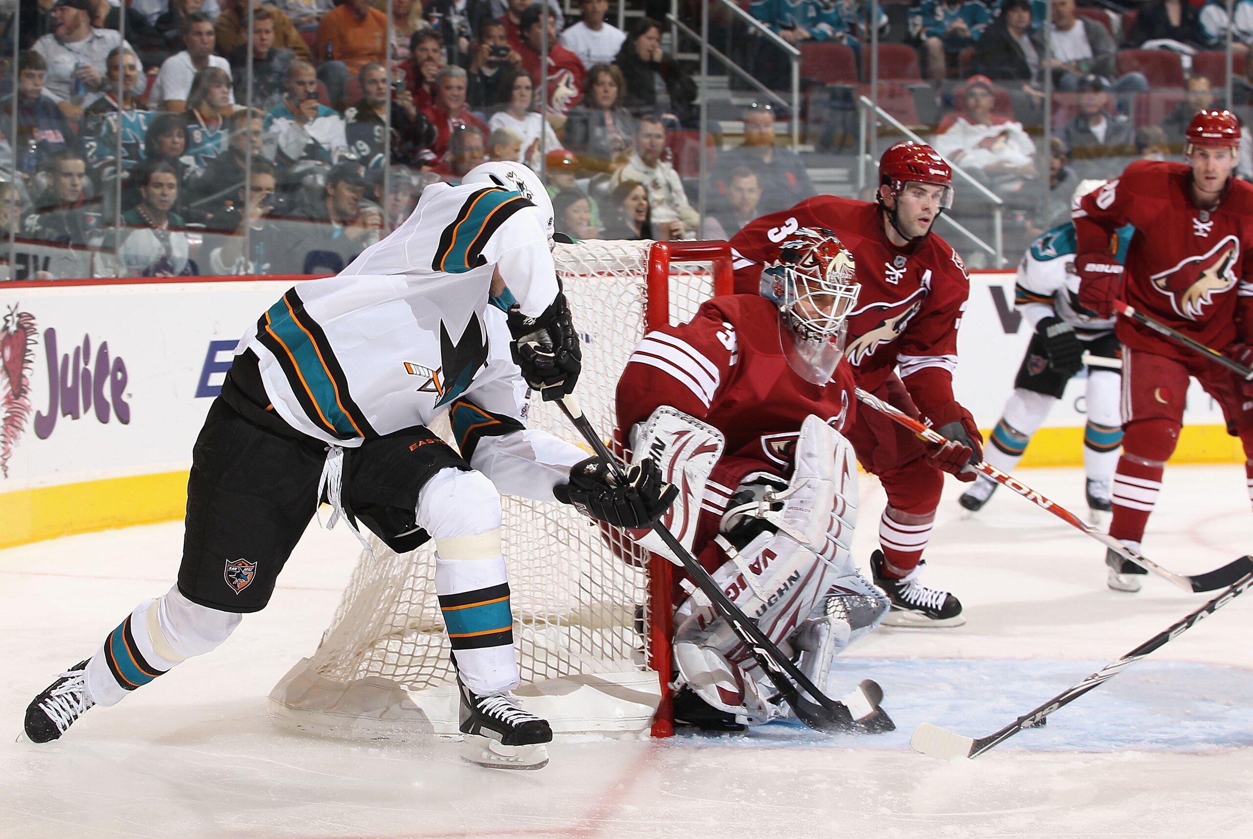 GLENDALE, AZ - MARCH 26:  Goaltender Ilya Bryzgalov #30 of the Phoenix Coyotes makes a pad save on the shot from Dany Heatley #15 of the San Jose Sharks during the NHL game at Jobing.com Arena on March 26, 2011 in Glendale, Arizona. The Sharks defeated th