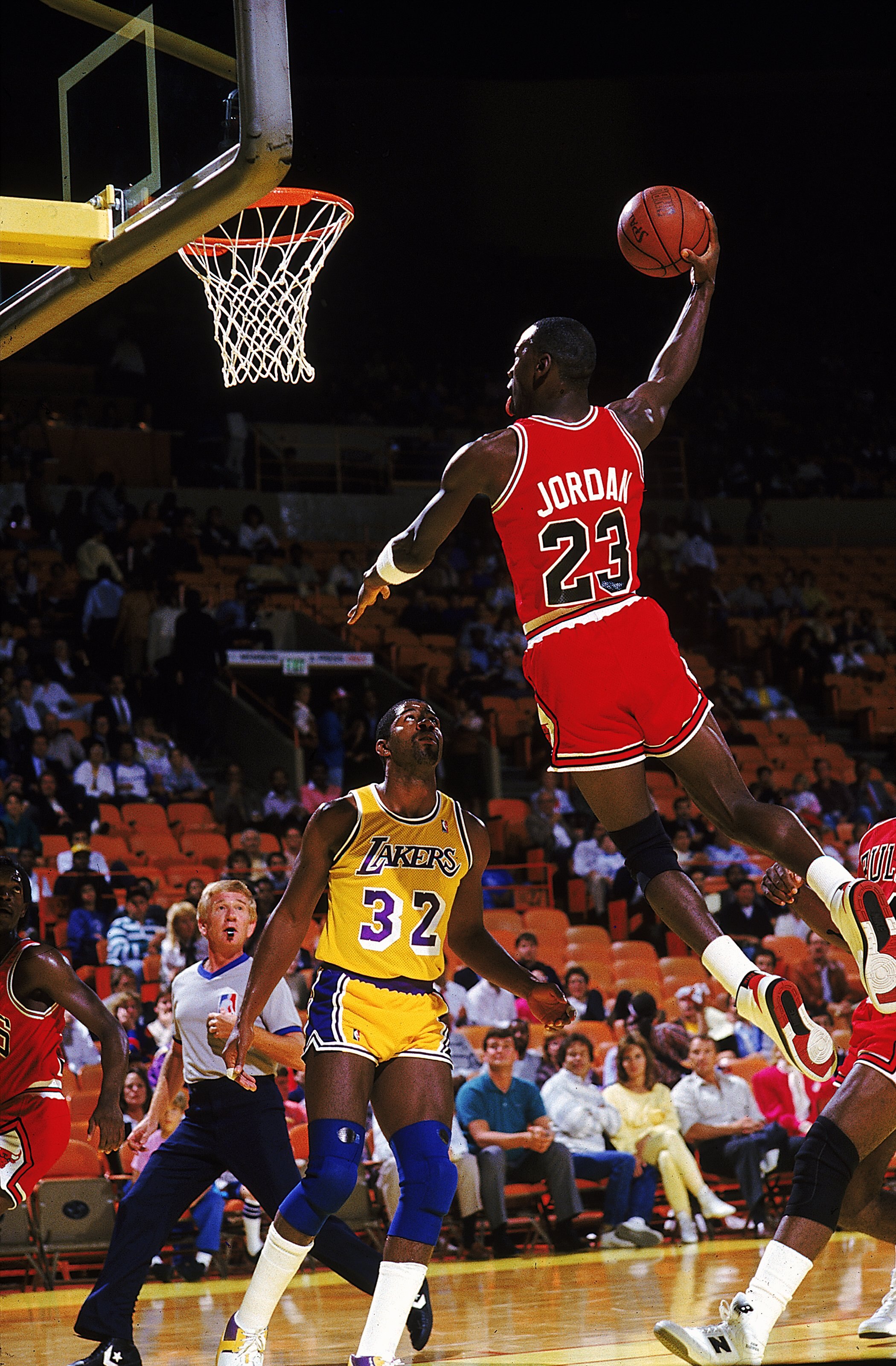 Michael Jordan #23 of the Chicago Bulls dunks the ball during a game against the Los Angeles Lakers.
