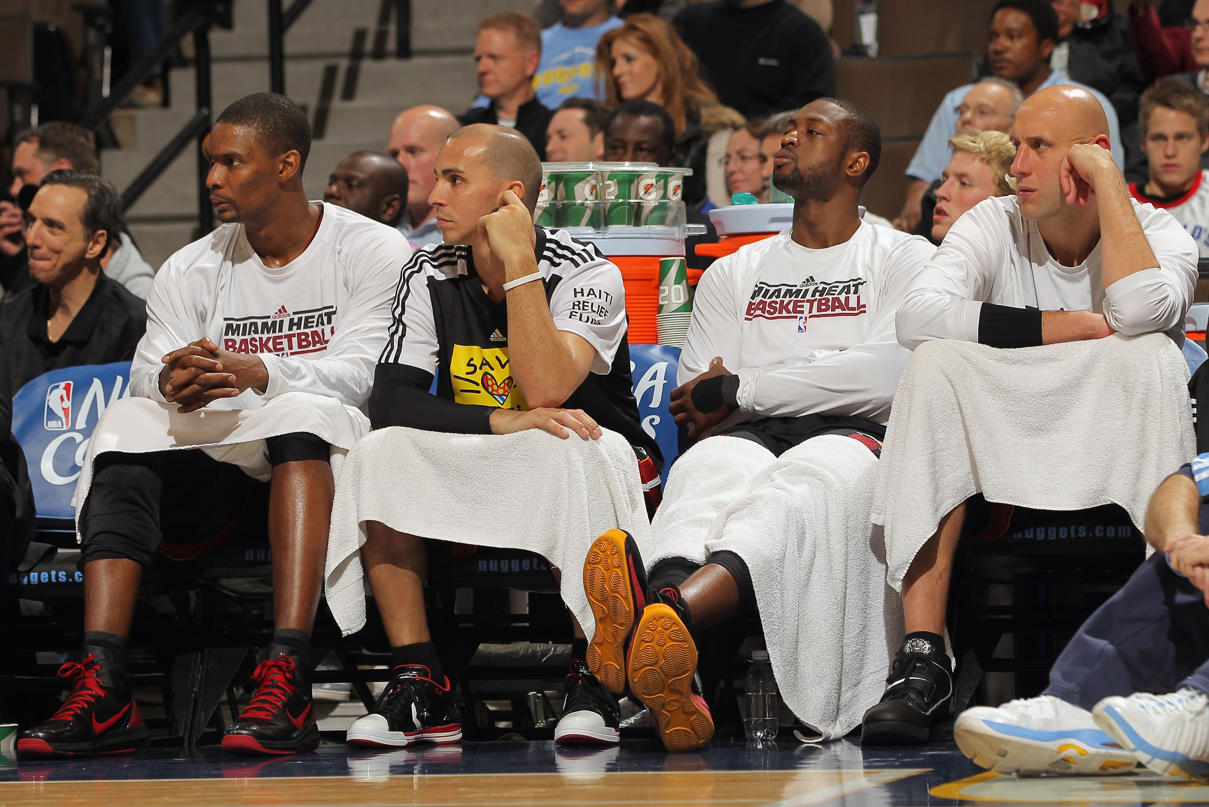 DENVER, CO - JANUARY 13:  (L-R) Chris Bosh #1, Carlos Arroyo #8, Dwayne Wade #3 and Zydrunas Ilgaukas #11 of the Miami Heat sit on the bench in the fourth quarter against the Denver Nuggets at the Pepsi Center on January 13, 2011 in Denver, Colorado. The