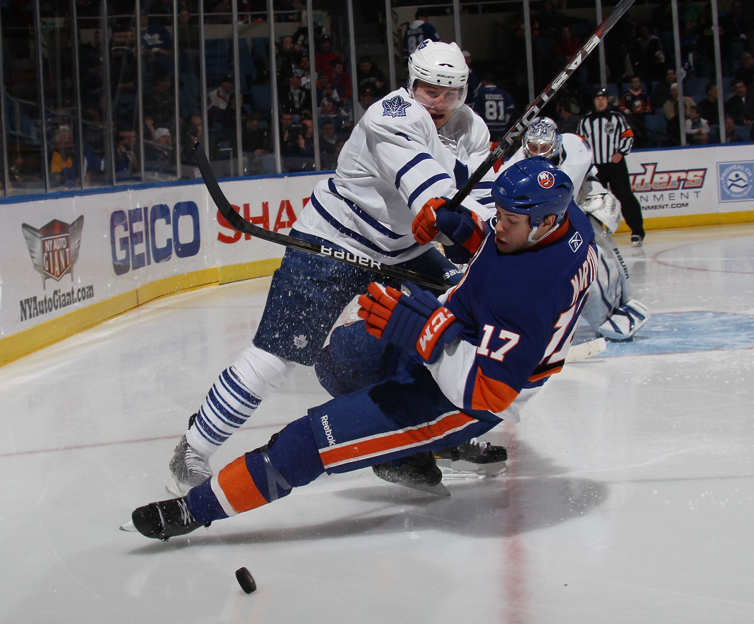 UNIONDALE, NY - MARCH 08: Luke Schenn #2 of the Toronto Maple Leafs hits Matt Martin #17 of the New York Islanders at the Nassau Coliseum on March 8, 2011 in Uniondale, New York.  (Photo by Bruce Bennett/Getty Images)