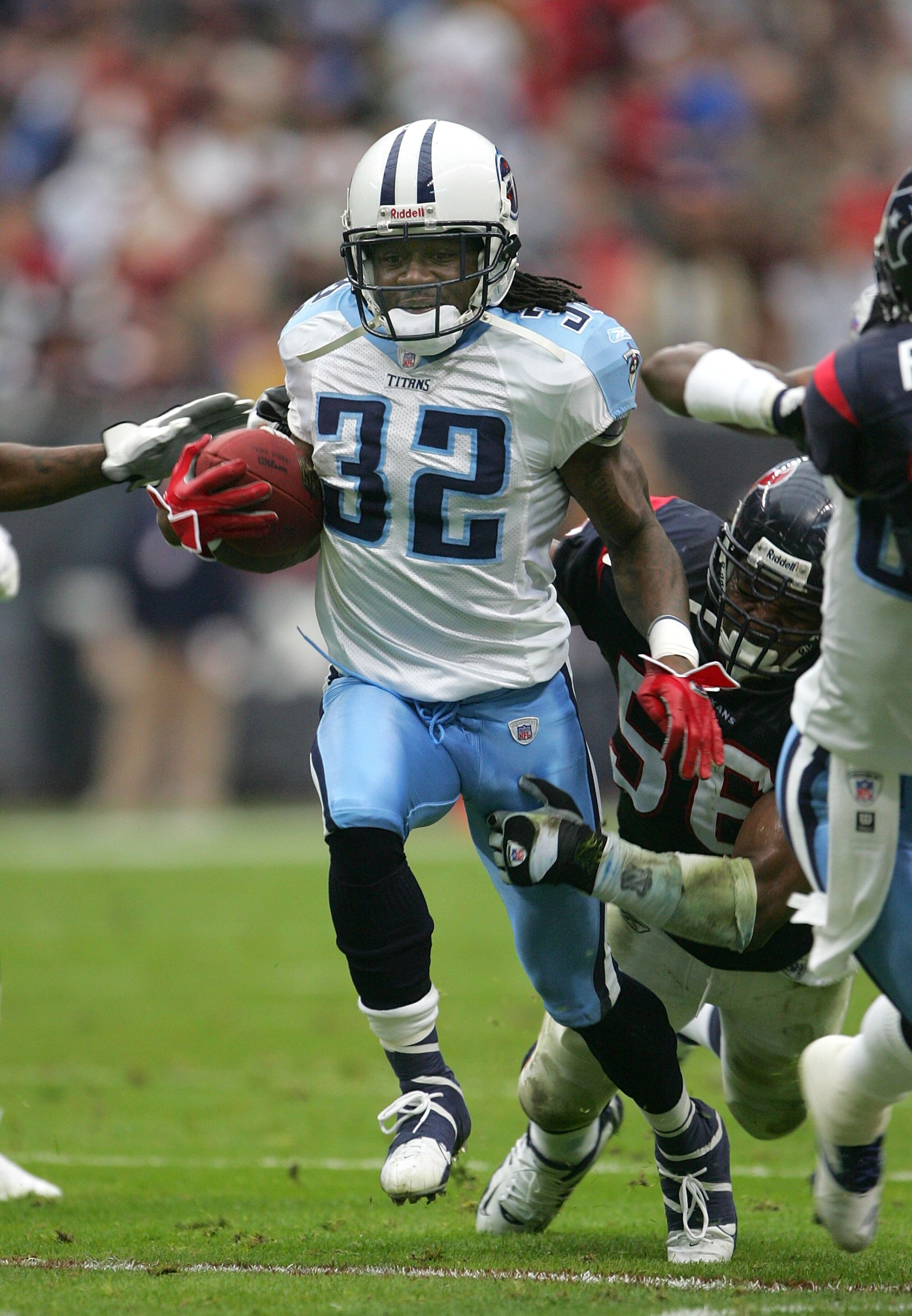 HOUSTON - DECEMBER 10:   Cornerback Pacman Jones #32 of the Tennessee Titans carries the ball on an offensive play as linebacker Morton Greenwood #56 of the Houston Texans defends on December 10, 2006 at Reliant Stadium in Houston, Texas.  The Titans won 