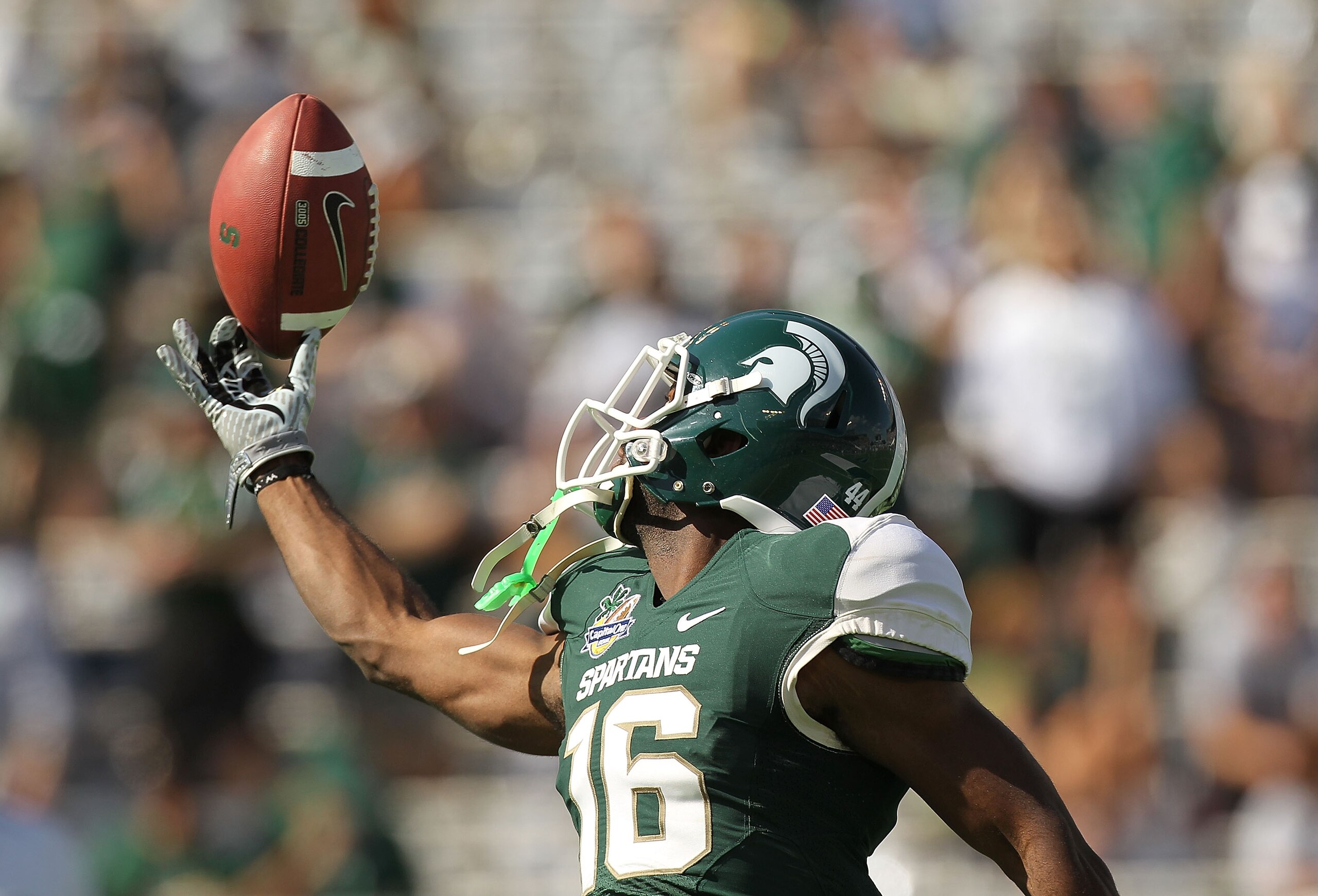 ORLANDO, FL - JANUARY 01:  Chris Rucker #16 of the Michigan State Spartans warms up during the Capitol One Bowl against the Alabama Crimson Tide at the Florida Citrus Bowl on January 1, 2011 in Orlando, Florida.  (Photo by Mike Ehrmann/Getty Images)