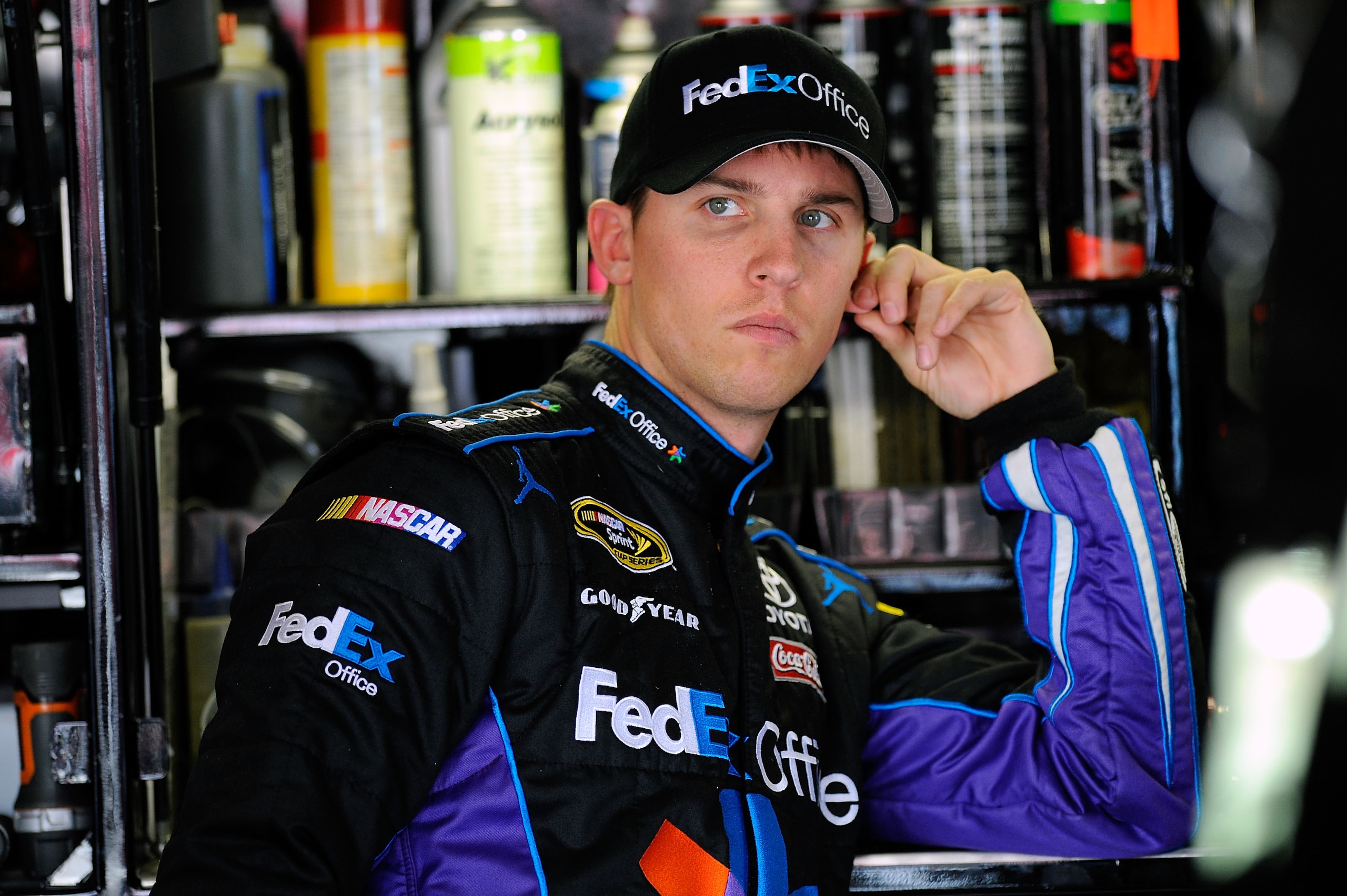 FONTANA, CA - MARCH 26:  Denny Hamlin, driver of the #11 FedEx Toyota, stands in the garage area during practice for the NASCAR Sprint Cup Series Auto Club 400 at Auto Club Speedway on March 26, 2011 in Fontana, California.  (Photo by Jared C. Tilton/Gett