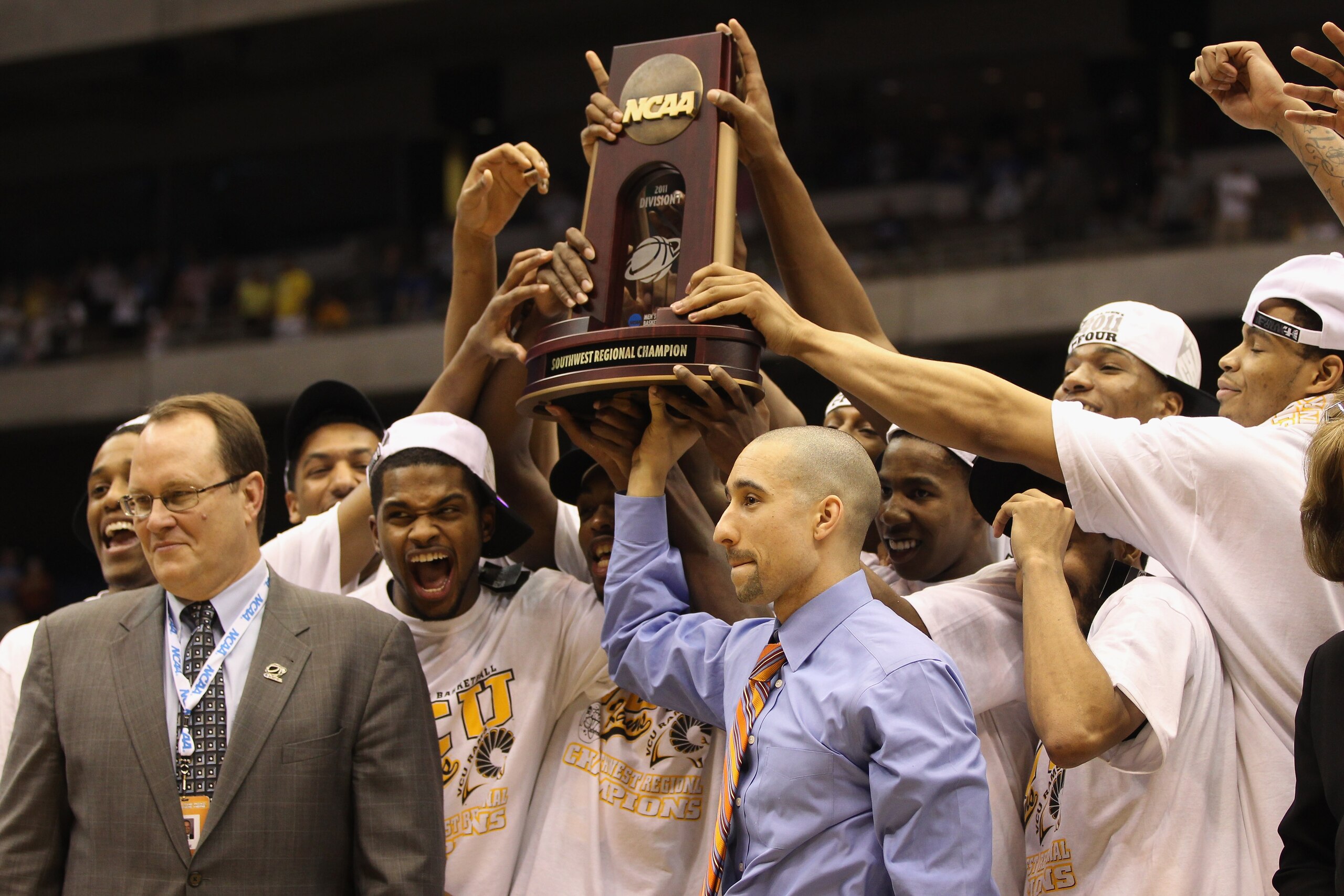 SAN ANTONIO, TX - MARCH 27:  Head coach Shaka Smart of the Virginia Commonwealth Rams holds up the trophy after defeating the Kansas Jayhawks during the southwest regional final of the 2011 NCAA men's basketball tournament at the Alamodome on March 27, 20