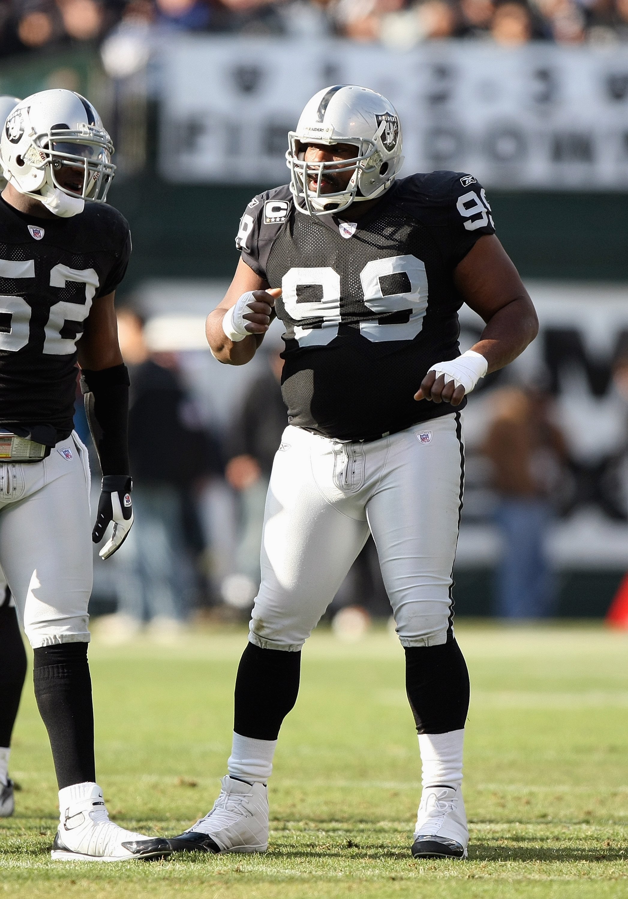 Warren Sapp of the Oakland Raiders watches from the sideline