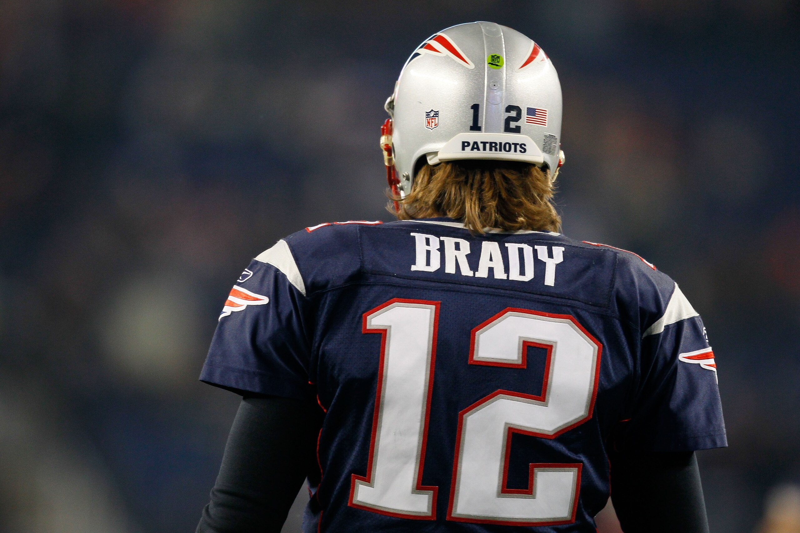 FOXBORO, MA - DECEMBER 19: Quarterback Tom Brady #12 of the New England Patriots looks on during warm-ups before playing against the Green Bay Packers at Gillette Stadium on December 19, 2010 in Foxboro, Massachusetts. (Photo by Jim Rogash/Getty Images) FOXBORO, MA - DECEMBER 19: Quarterback Tom Brady #12 of the New England Patriots looks on during warm-ups before playing against the Green Bay Packers at Gillette Stadium on December 19, 2010 in Foxboro, Massachusetts. (Photo by Jim Rogash/Getty Images)