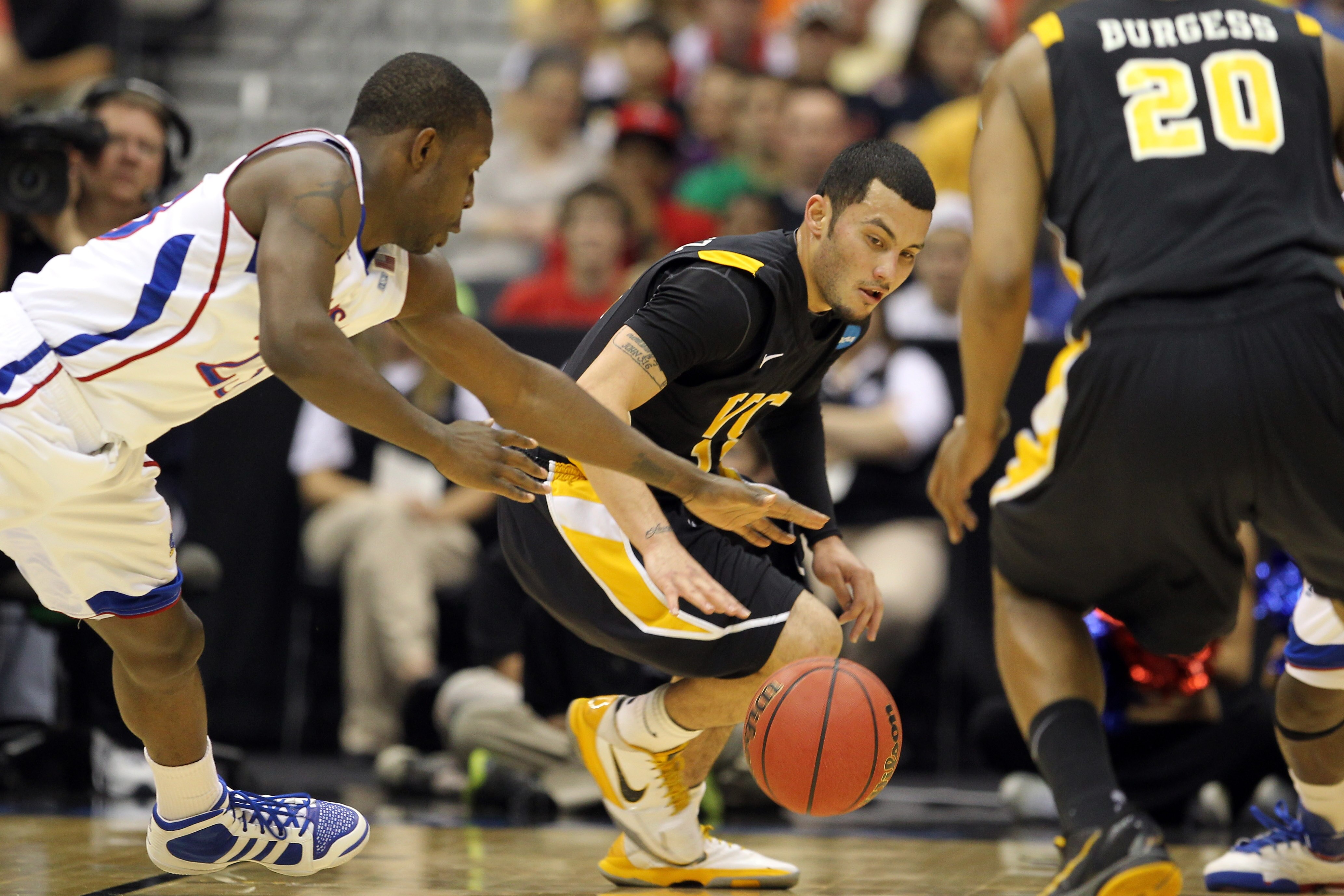SAN ANTONIO, TX - MARCH 27:  Joey Rodriguez #12 of the Virginia Commonwealth Rams and Mario Little #23 of the Kansas Jayhawks go for the loose ball during the southwest regional final of the 2011 NCAA men's basketball tournament at the Alamodome on March