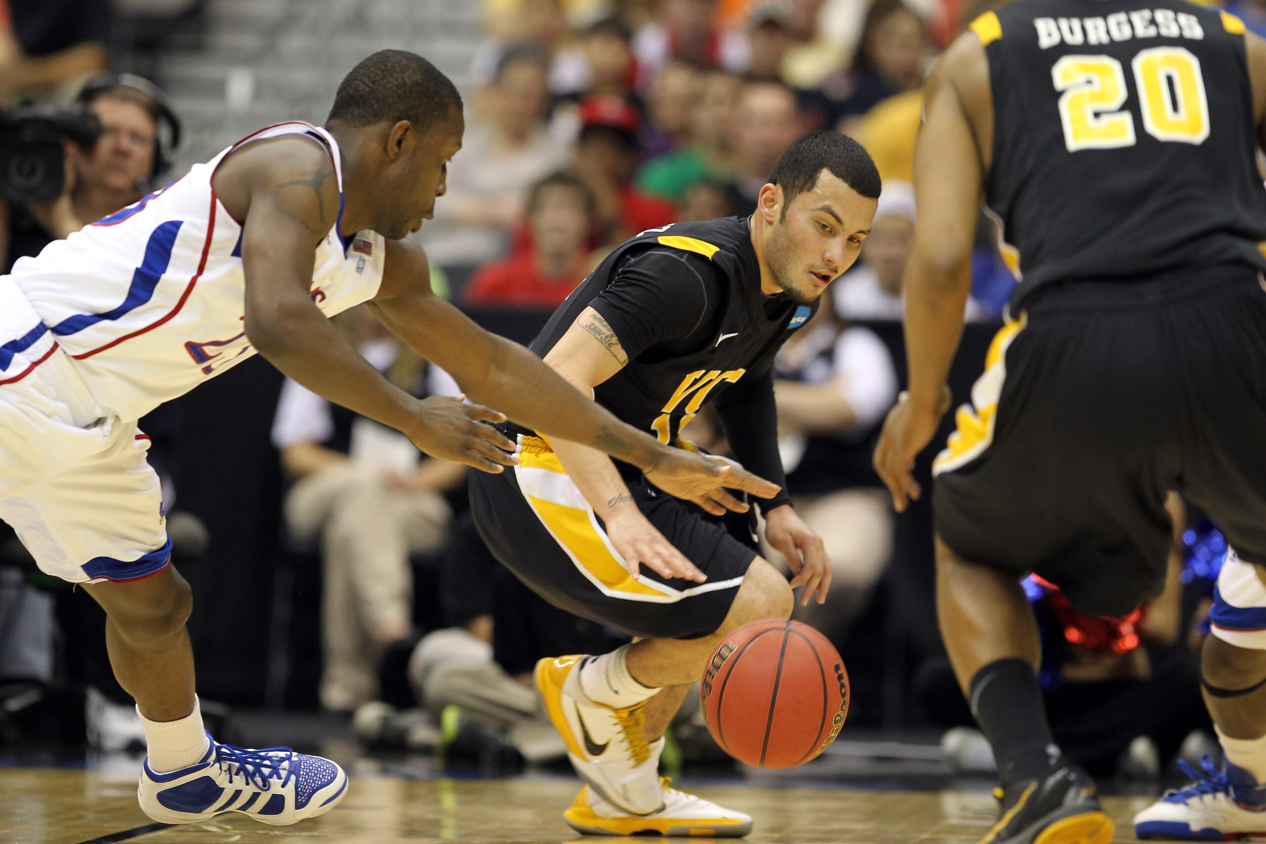 SAN ANTONIO, TX - MARCH 27:  Joey Rodriguez #12 of the Virginia Commonwealth Rams and Mario Little #23 of the Kansas Jayhawks go for the loose ball during the southwest regional final of the 2011 NCAA men's basketball tournament at the Alamodome on March