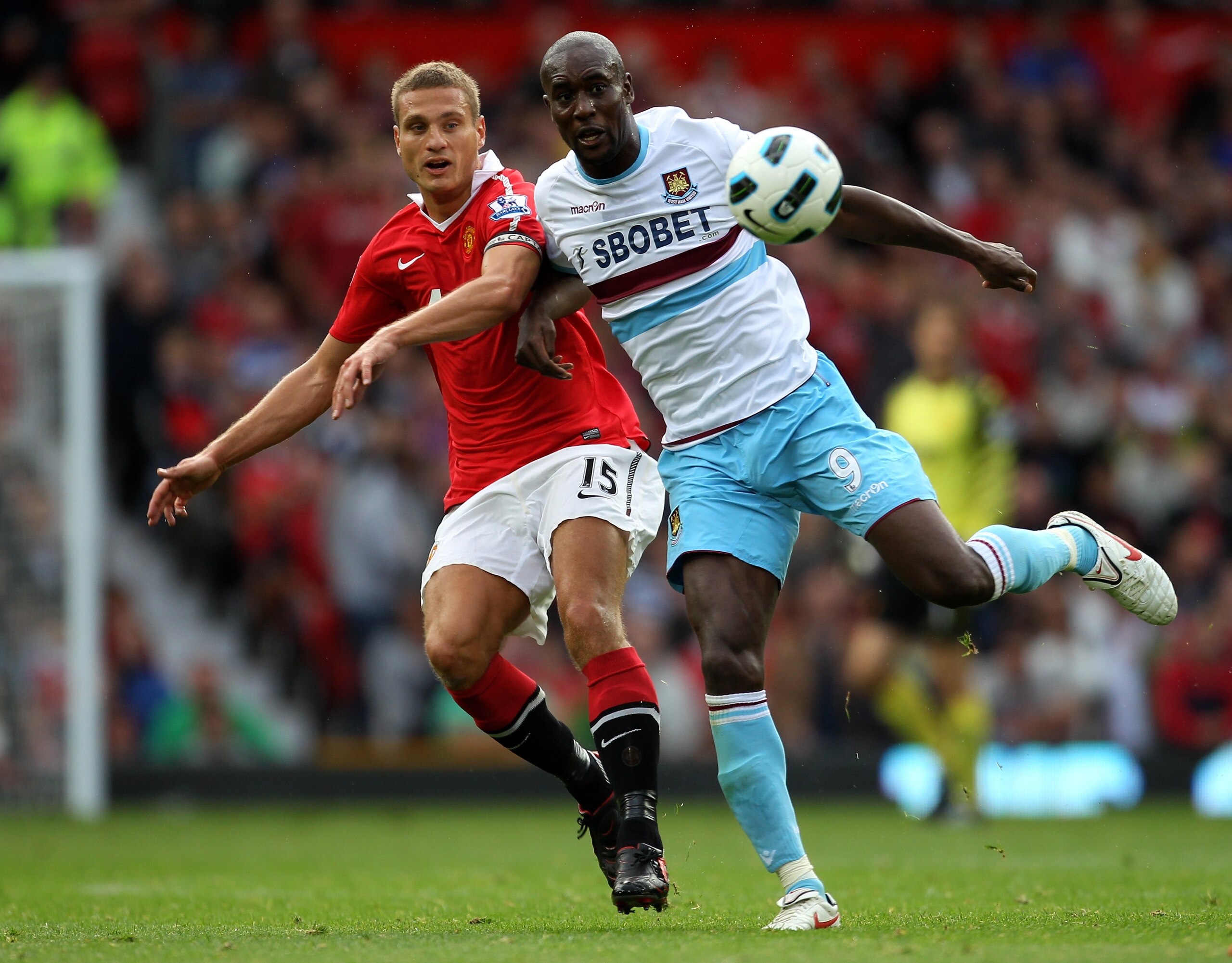 MANCHESTER, ENGLAND - AUGUST 28:  Carlton Cole of West Ham United tangles with Nemanja Vidic of Manchester United during the Barclays Premier League match between Manchester United and West Ham United at Old Trafford on August 28, 2010 in Manchester, Engl