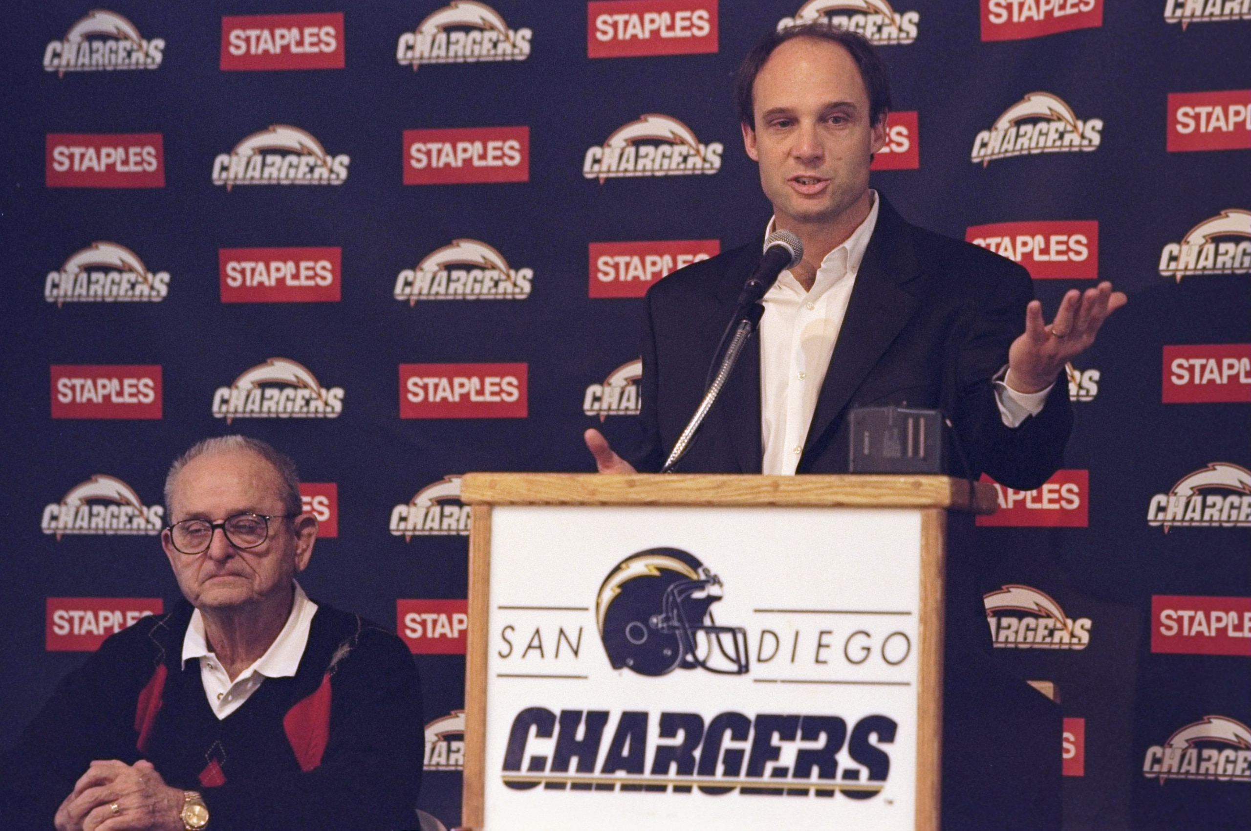 7 Jan 1999: Mike Reilly speaking about becoming the New Head Coach of the San Diego Chargers while the Owner Alex Spanos sits next to him during the Chargers Press Conference at the San Diego Training Facility in San Diego, California. 7 Jan 1999: Mike Reilly speaking about becoming the New Head Coach of the San Diego Chargers while the Owner Alex Spanos sits next to him during the Chargers Press Conference at the San Diego Training Facility in San Diego, California.
