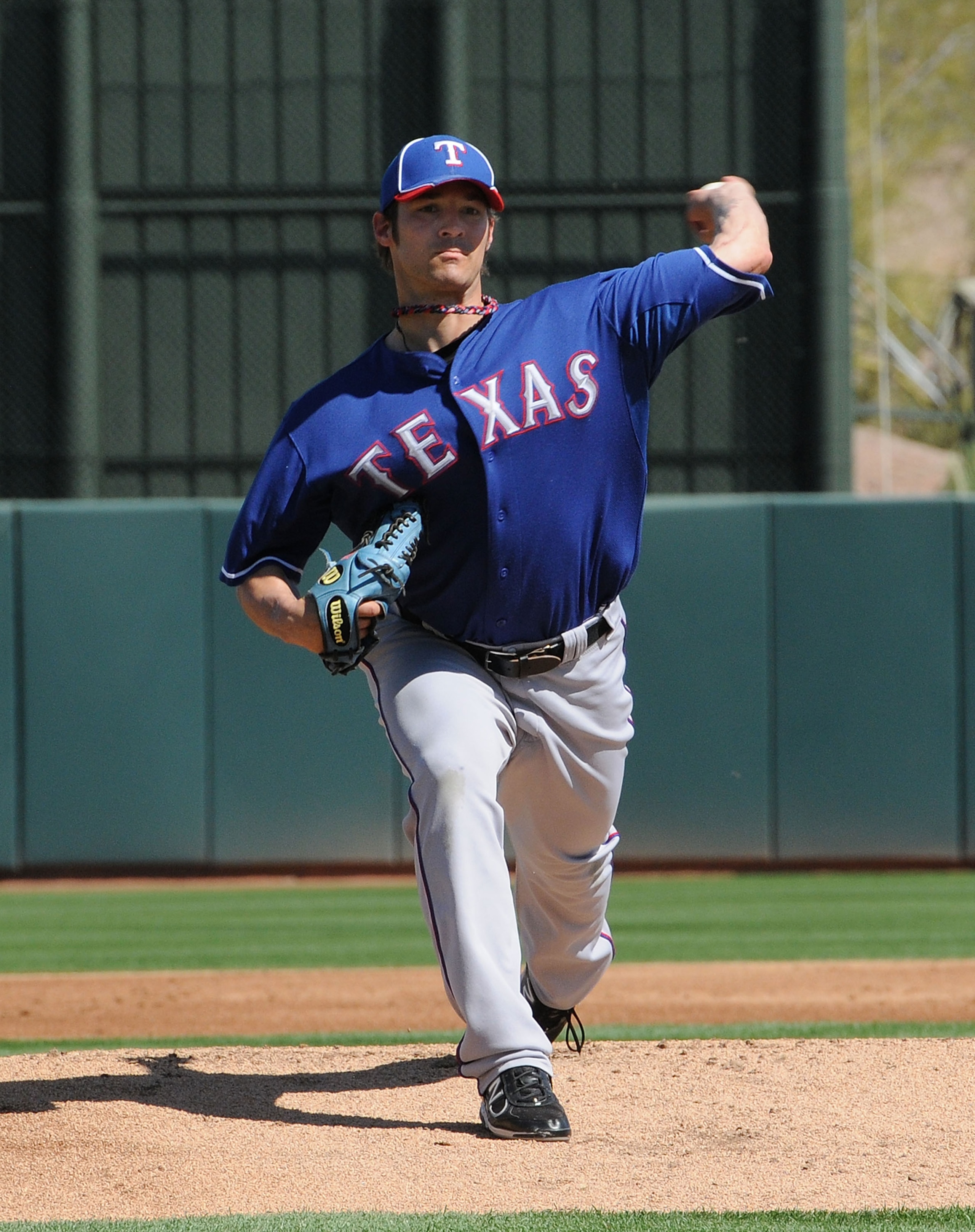 PHOENIX, AZ - MARCH 04: C.J. Wilson #36 of the Texas Rangers delivers a pitch against the Oakland Athletics at Phoenix Municipal Stadium on March 4, 2011 in Phoenix, Arizona. (Photo by Norm Hall/Getty Images) PHOENIX, AZ - MARCH 04: C.J. Wilson #36 of the Texas Rangers delivers a pitch against the Oakland Athletics at Phoenix Municipal Stadium on March 4, 2011 in Phoenix, Arizona. (Photo by Norm Hall/Getty Images)
