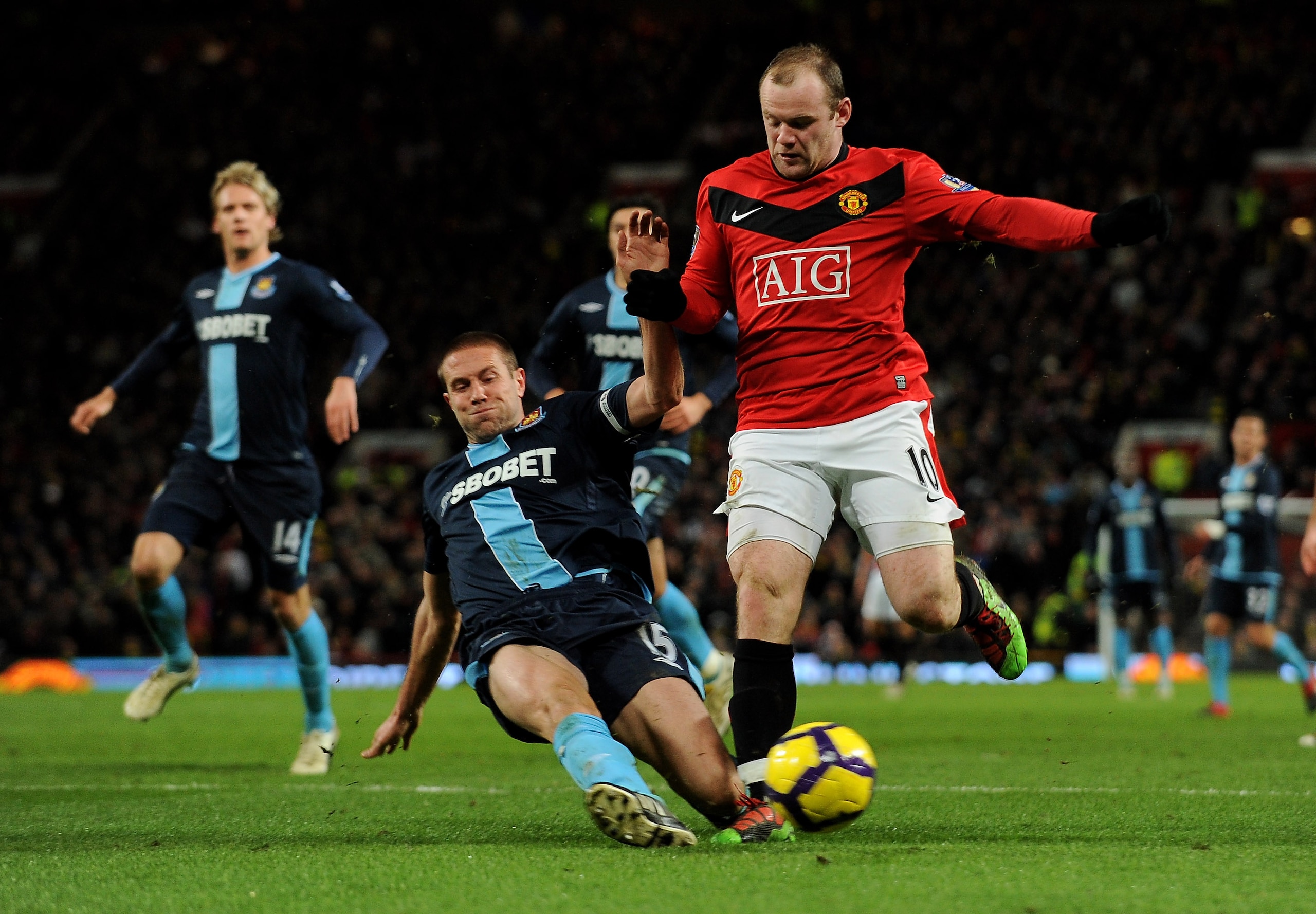 MANCHESTER, ENGLAND - FEBRUARY 23:  Wayne Rooney (R) of Manchester United is tackled by Matthew Upson of West Ham during the Barclays Premier League match between Manchester United and West Ham United at Old Trafford on February 23, 2010 in Manchester, En