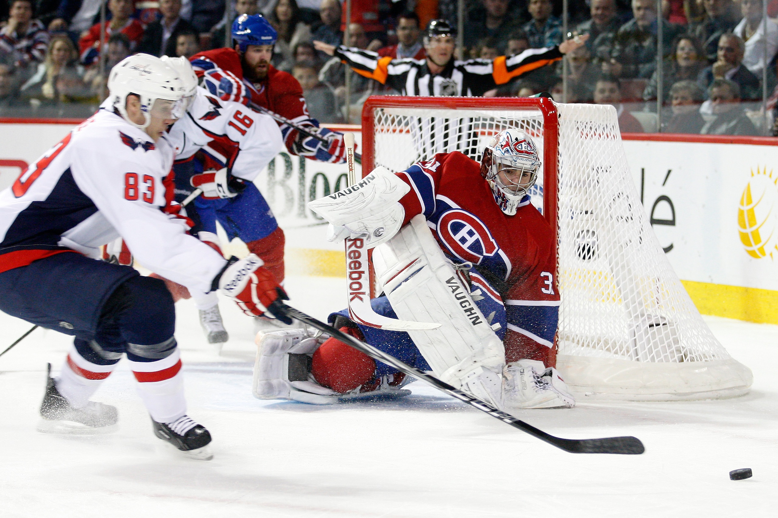 MONTREAL, CANADA - MARCH 15:  Goalie Carey Price #31 of the Montreal Canadiens watches a puck rebound  in front of Jay Beagle #83 of the Washington Capitals during the NHL game at the Bell Centre on March 15, 2011 in Montreal, Quebec, Canada.  The Capital
