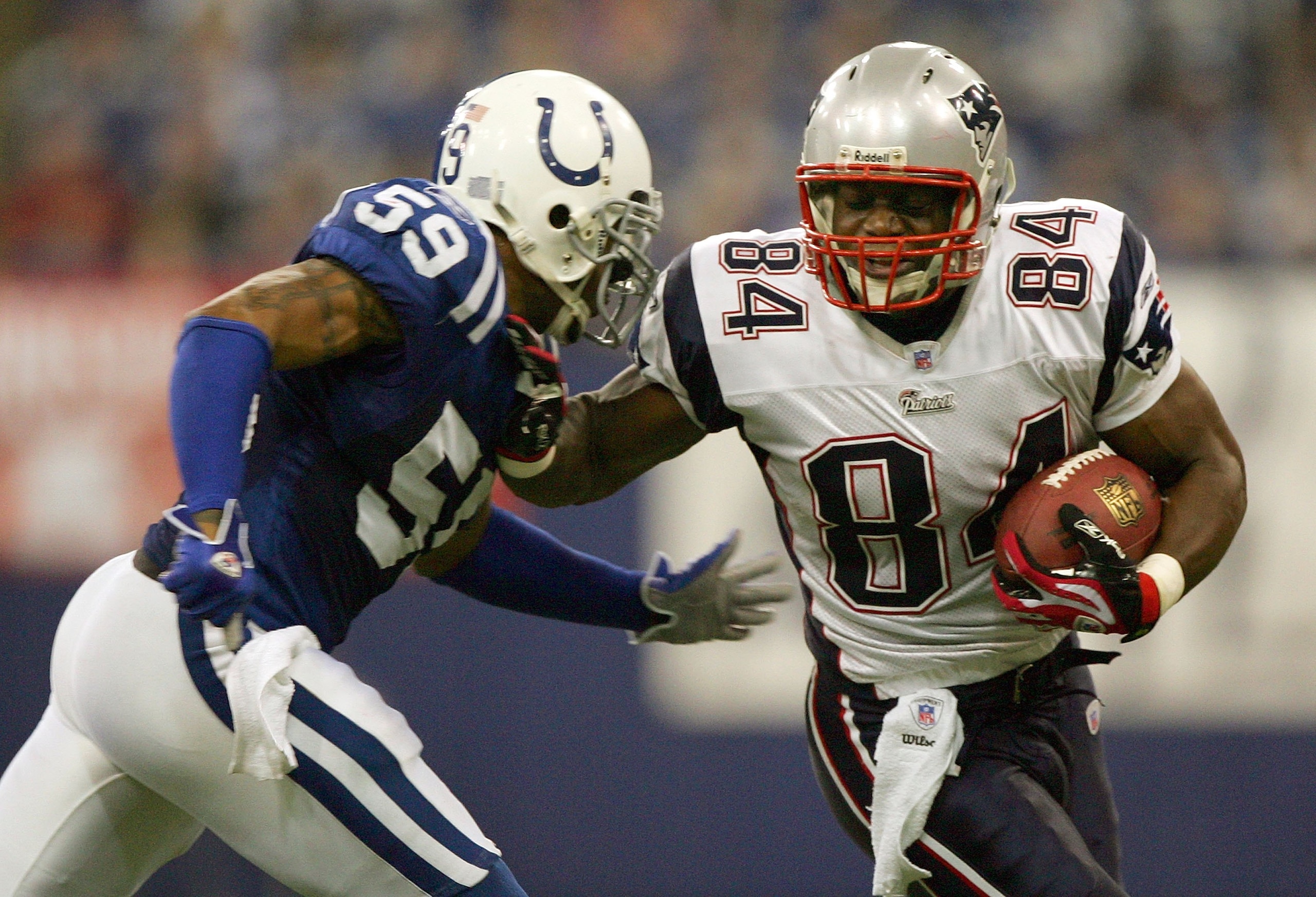INDIANAPOLIS - JANUARY 21:  Benjamin Watson #84 of the New England Patriots tries to get past Cato June #59 of the Indianapolis Colts during the AFC Championship Game on January 21, 2007 at the RCA Dome in Indianapolis, Indiana.  (Photo by Jed Jacobsohn/G