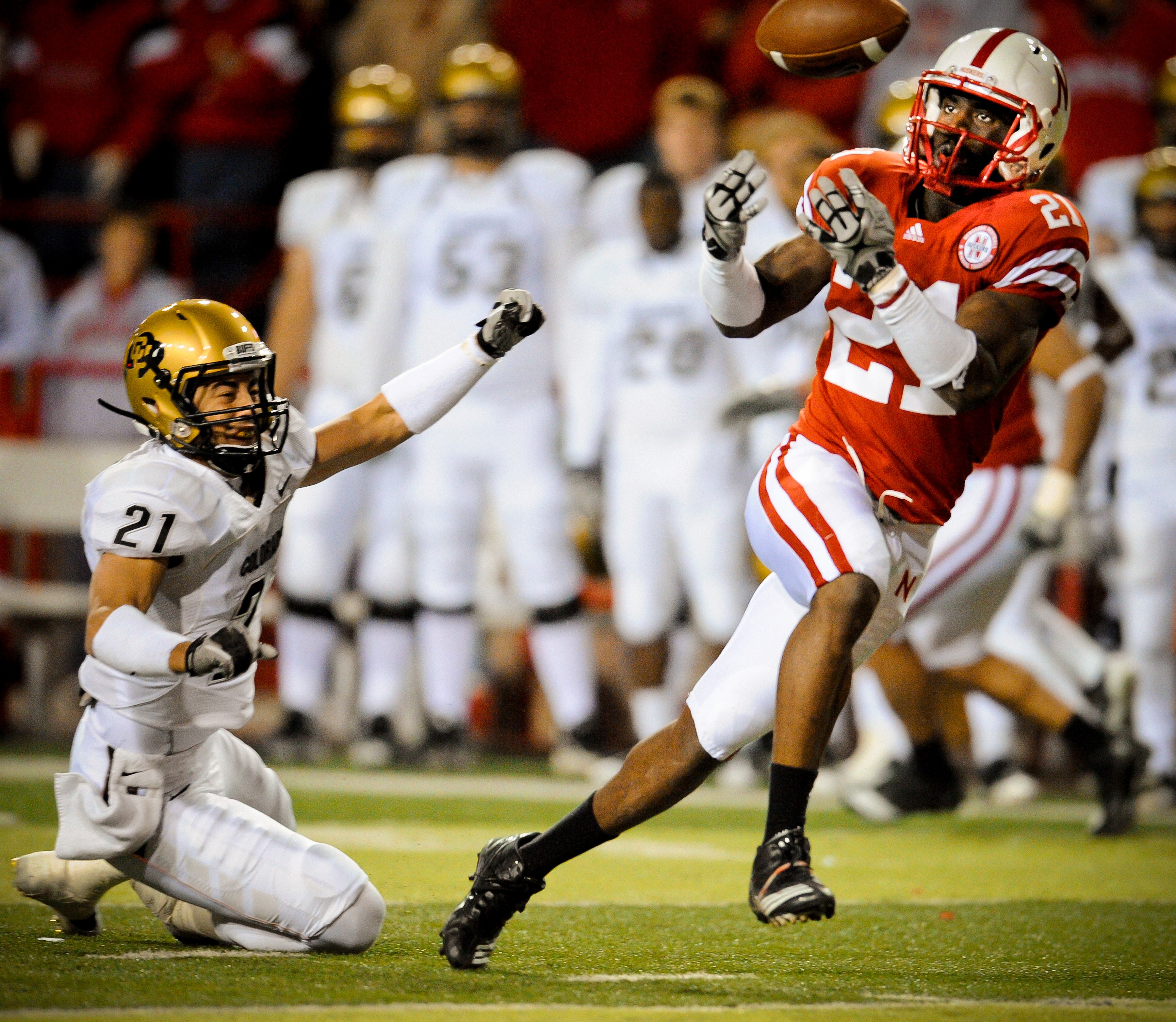LINCOLN, NE - NOVEMBER 26: Prince Amukamara #21 of the Nebraska Cornhuskers misses a chance at an interception from Scotty McKnight #21 of the Colorado Buffaloes during the second half of their game at Memorial Stadium on November 26, 2010 in Lincoln, Neb