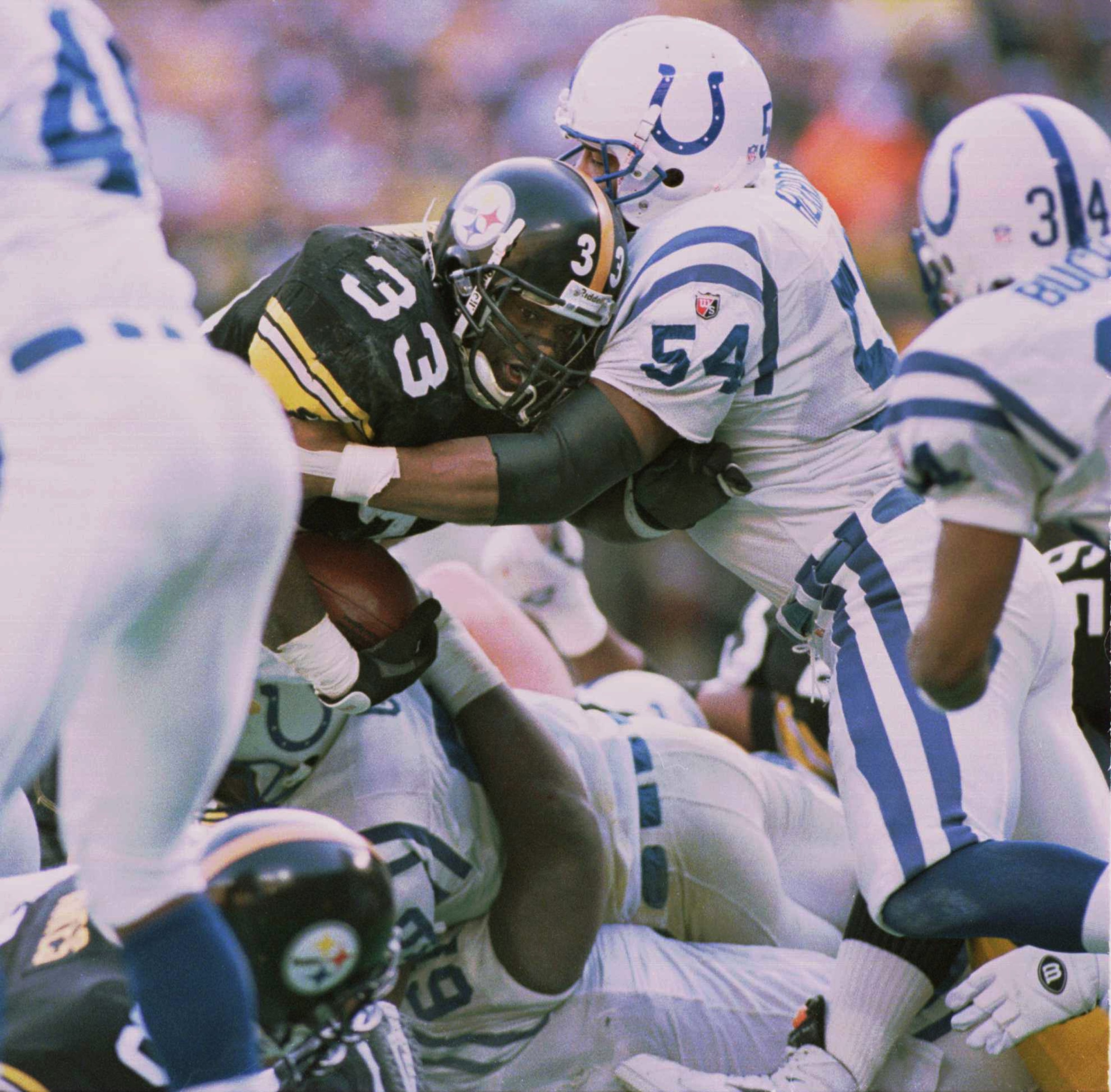 14 JAN 1996:  RUNNING BACK #33 BAM MORRIS OF THE PITTSBURGH STEELERS MUSCLES HIS WAY PAST JEFF HERROD #54 OF THE INDIANAPOLIS COLTS AND OTHER COLT DEFENSE FOR THE GAME WINNING TOUCHDOWN IN THE AFC CHAMPIONSHIP GAME AT THREE RIVERS STADIUM, PITTSBURGH, PEN