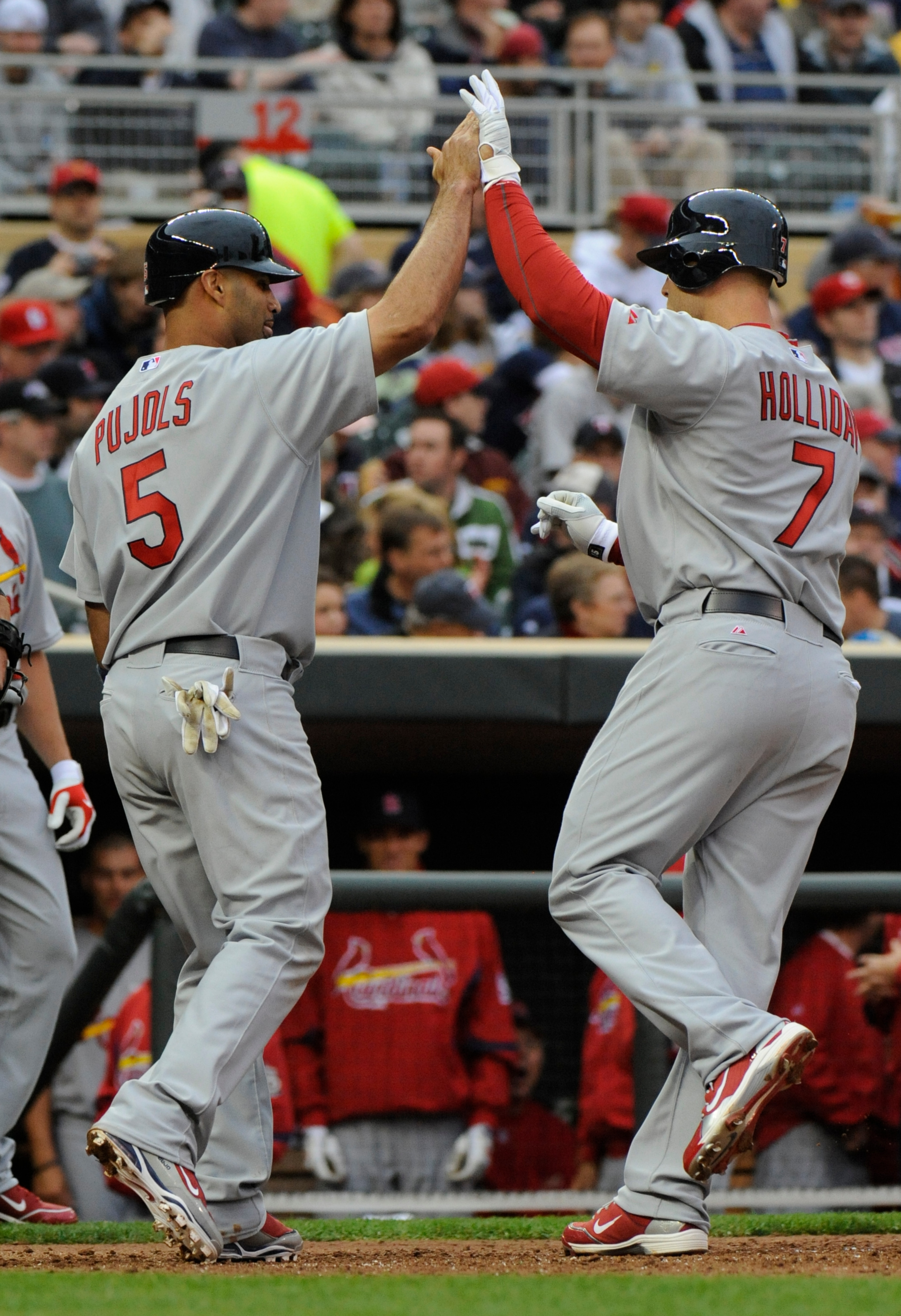 MINNESOTA, MN - APRIL 2: Albert Pujols #5 and Matt Holliday #7 of St. Louis Cardinals celebrate Holliday's fourth inning two-run homerun against the Minnesota Twins during an exhibition game at Target Field on April 2, 2010 in Minneapolis, Minnesota. Card MINNESOTA, MN - APRIL 2: Albert Pujols #5 and Matt Holliday #7 of St. Louis Cardinals celebrate Holliday's fourth inning two-run homerun against the Minnesota Twins during an exhibition game at Target Field on April 2, 2010 in Minneapolis, Minnesota. Card
