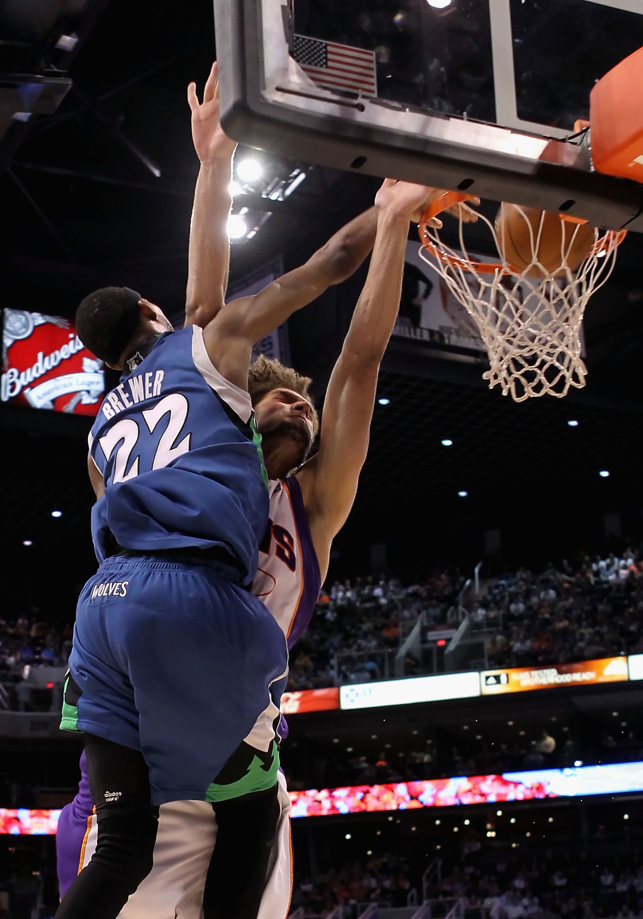 PHOENIX - MARCH 16:  Corey Brewer #22 of the Minnesota Timberwolves slam dunks the ball over Robin Lopez #15 of the Phoenix Suns during the NBA game at US Airways Center on March 16, 2010 in Phoenix, Arizona. NOTE TO USER: User expressly acknowledges and