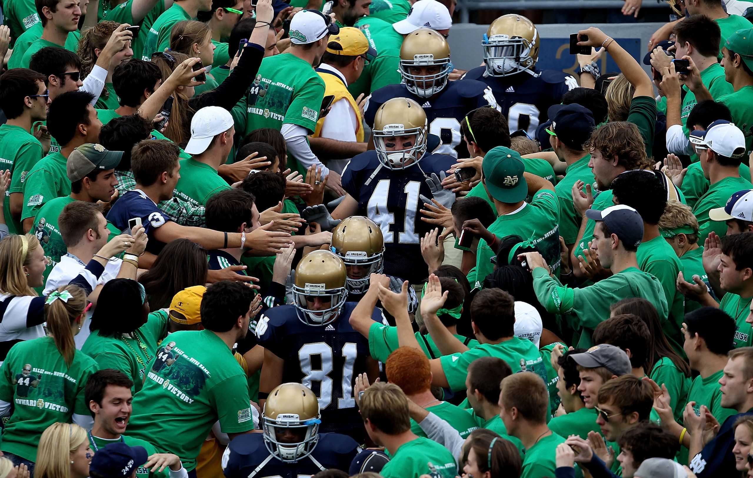 SOUTH BEND, IN - SEPTEMBER 04: Players from the Notre Dame Fighting Irish walk to the field through the student section for warm-ups before a game against the Purdue Boilermakers at Notre Dame Stadium on September 4, 2010 in South Bend, Indiana. Notre Dam
