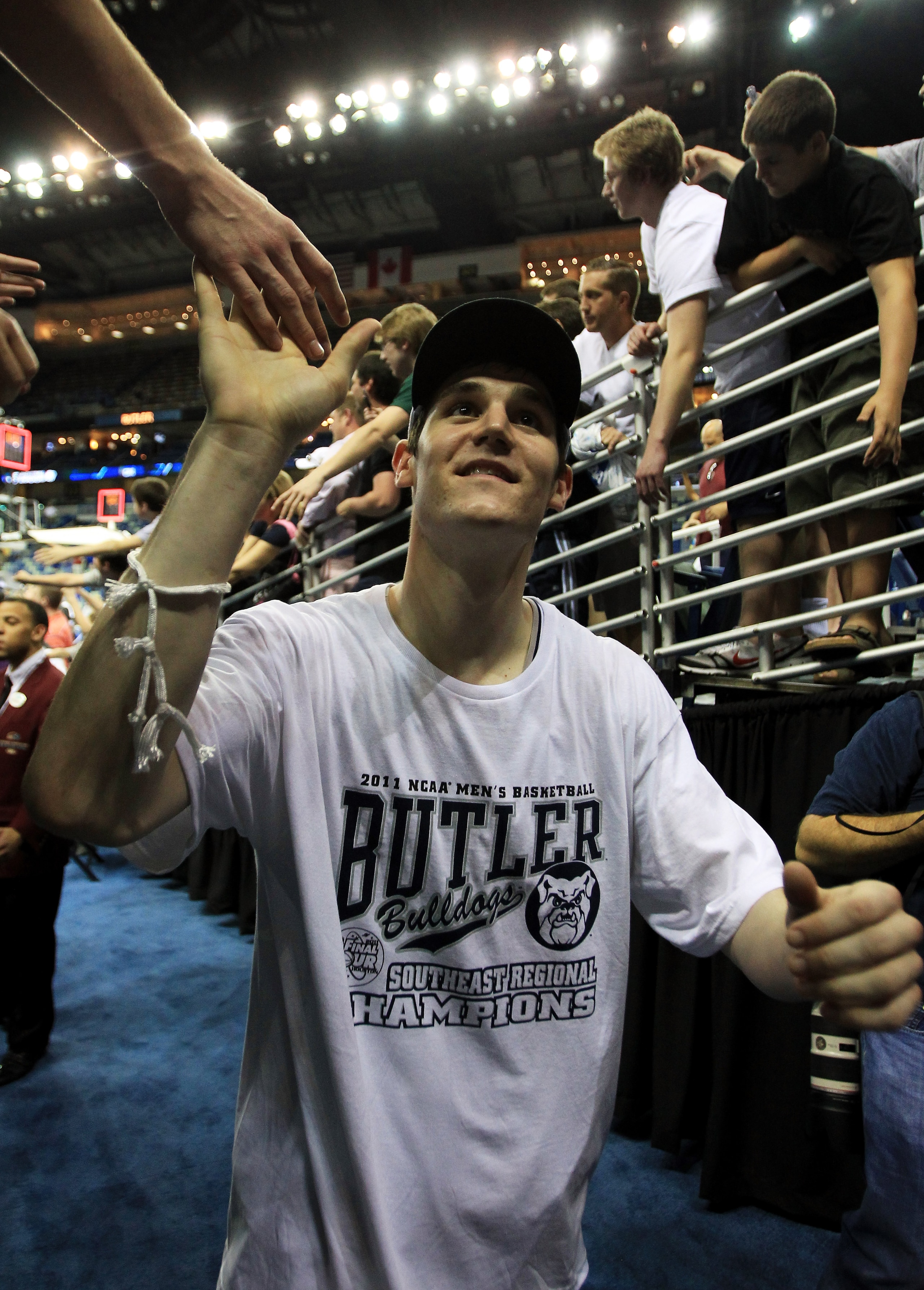 NEW ORLEANS, LA - MARCH 26:  Andrew Smith #44 of the Butler Bulldogs celebrates with fans after defeating the Florida Gators 74 to 71 in overtime during the Southeast regional final of the 2011 NCAA men's basketball tournament at New Orleans Arena on Marc