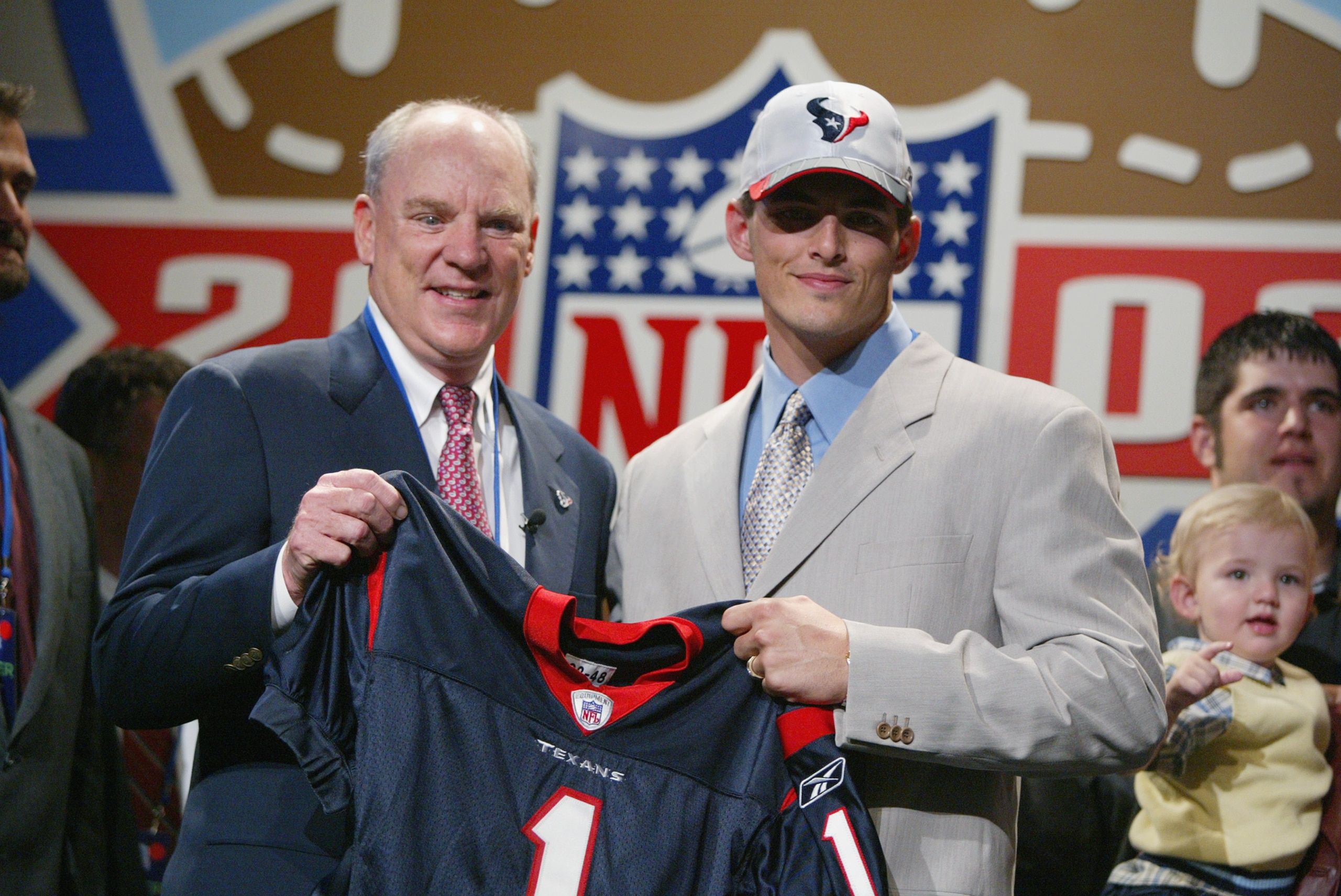 NEW YORK - APRIL 20:   David Carr of Fresno State poses with Houston Texans owner Robert McNair after Carr was chosen first overall by the Texans in the NFL Draft at the Theatre in Madison Square Garden in New York City, New York on April 20, 2002..   Dig