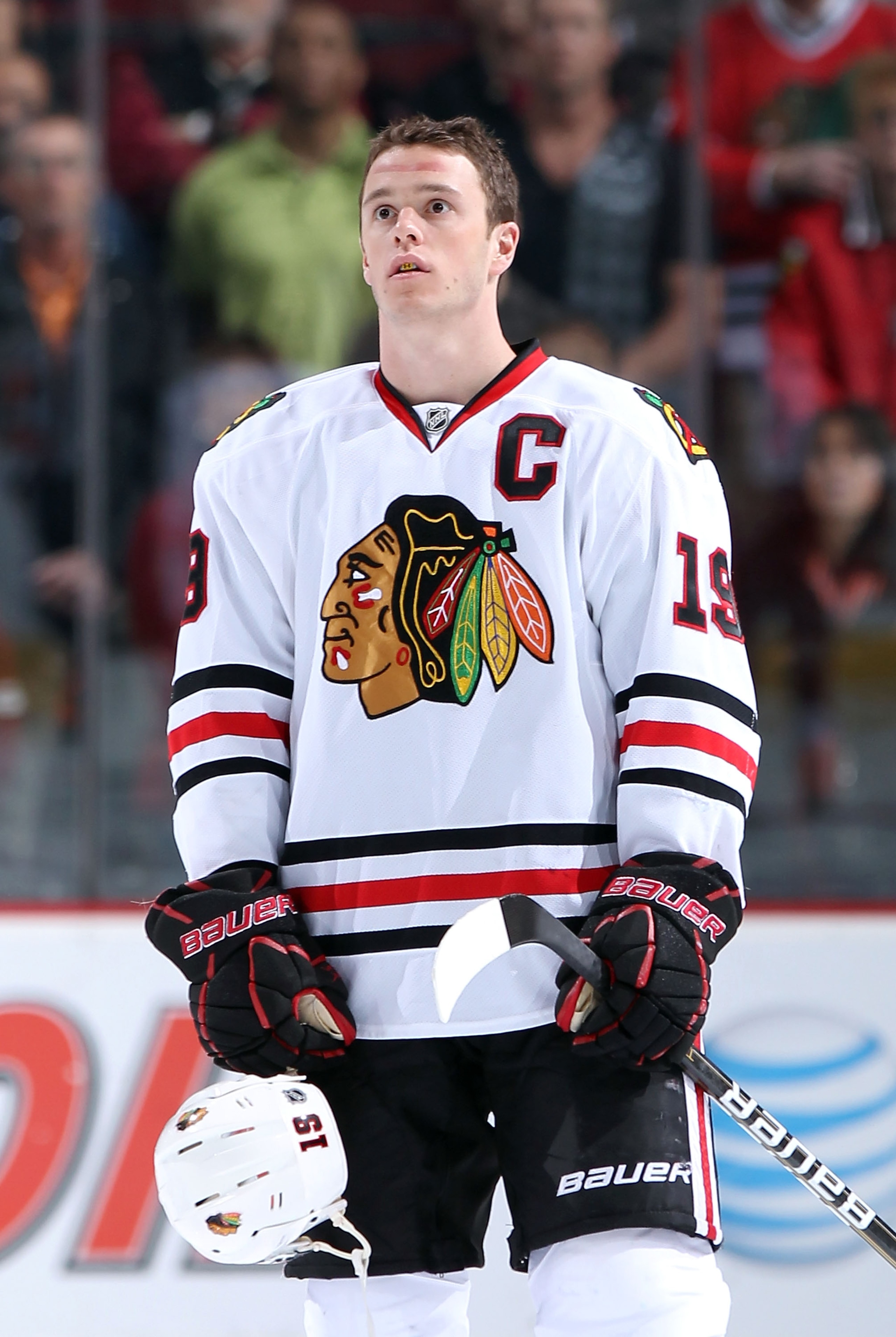 GLENDALE, AZ - MARCH 20:  Jonathan Toews #19 of the Chicago Blackhawks stands attended for the National Anthem before the NHL game against the Phoenix Coyotes at Jobing.com Arena on March 20, 2011 in Glendale, Arizona. The Blackhawks defeated the Coyotes