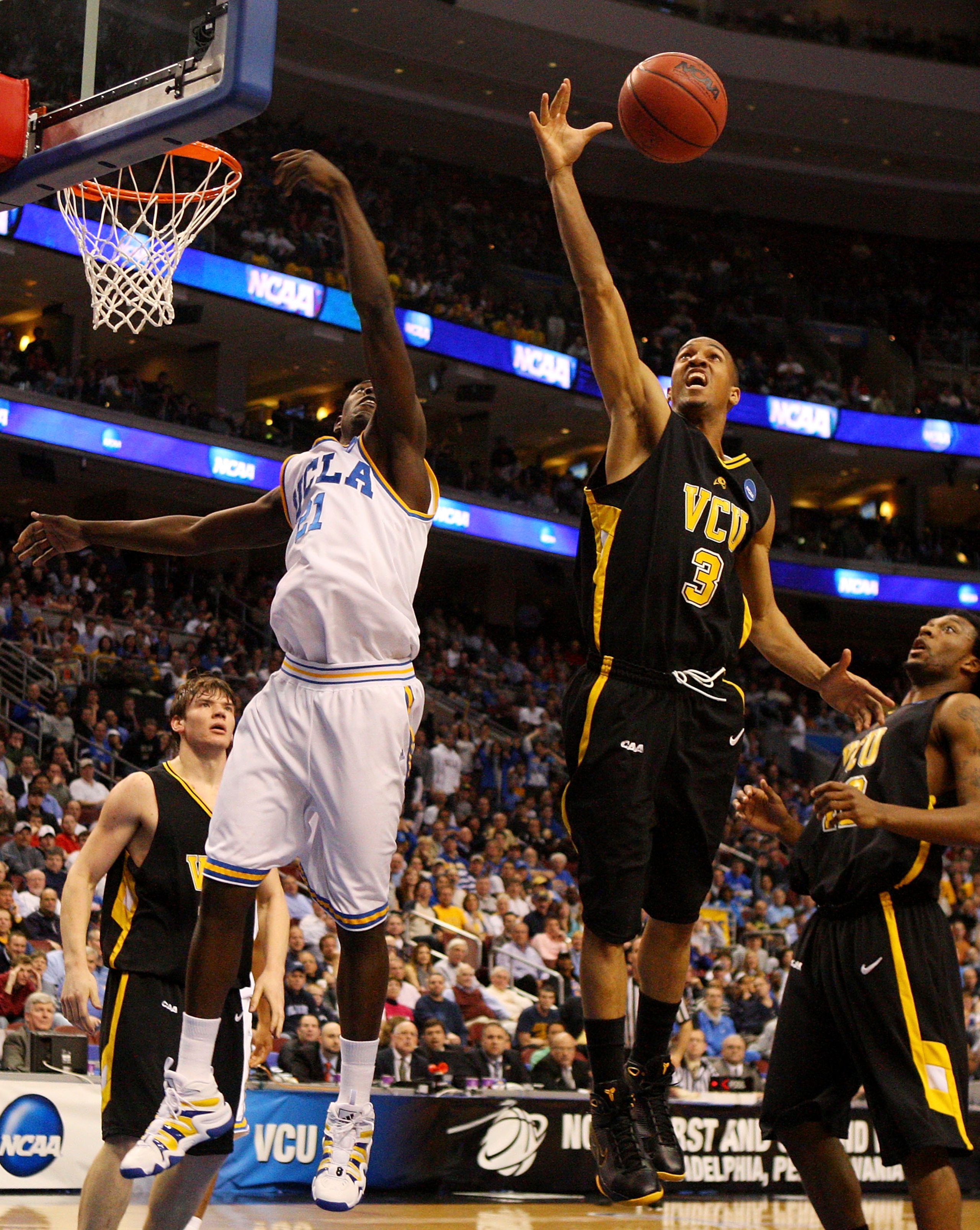 PHILADELPHIA - MARCH 19:  Eric Maynor #3 of the VCU Rams rebounds against Jrue Holiday #21 of the UCLA Bruins during the first round of the NCAA Division I Men's Basketball Tournament at the Wachovia Center on March 19, 2009 in Philadelphia, Pennsylvania.