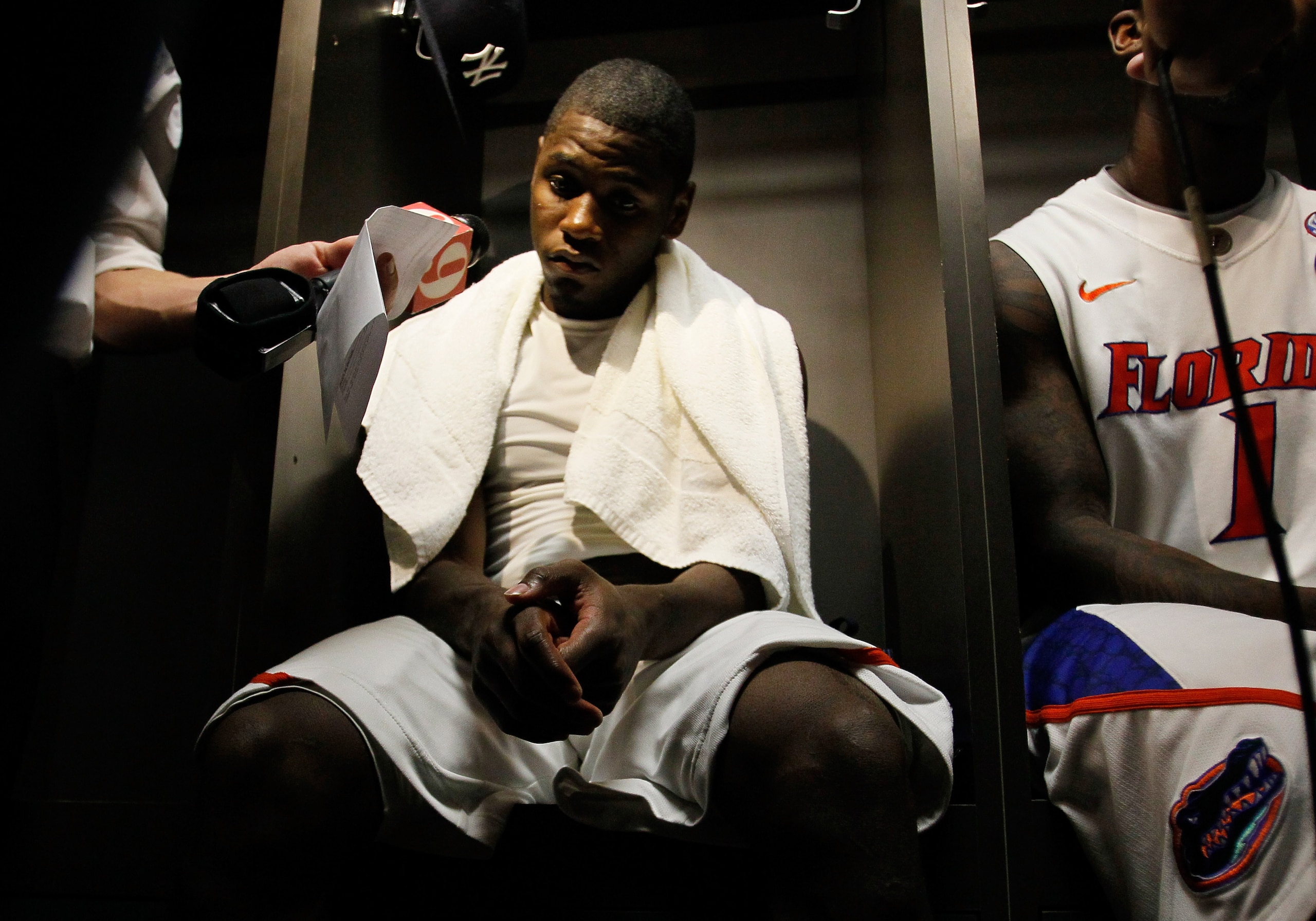 NEW ORLEANS, LA - MARCH 26:  Erving Walker #11 and Kenny Boynton #1 of the Florida Gators are interviewed in the lockerroom after their 71 to 74 loss ot the Butler Bulldogs during the Southeast regional final of the 2011 NCAA men's basketball tournament a