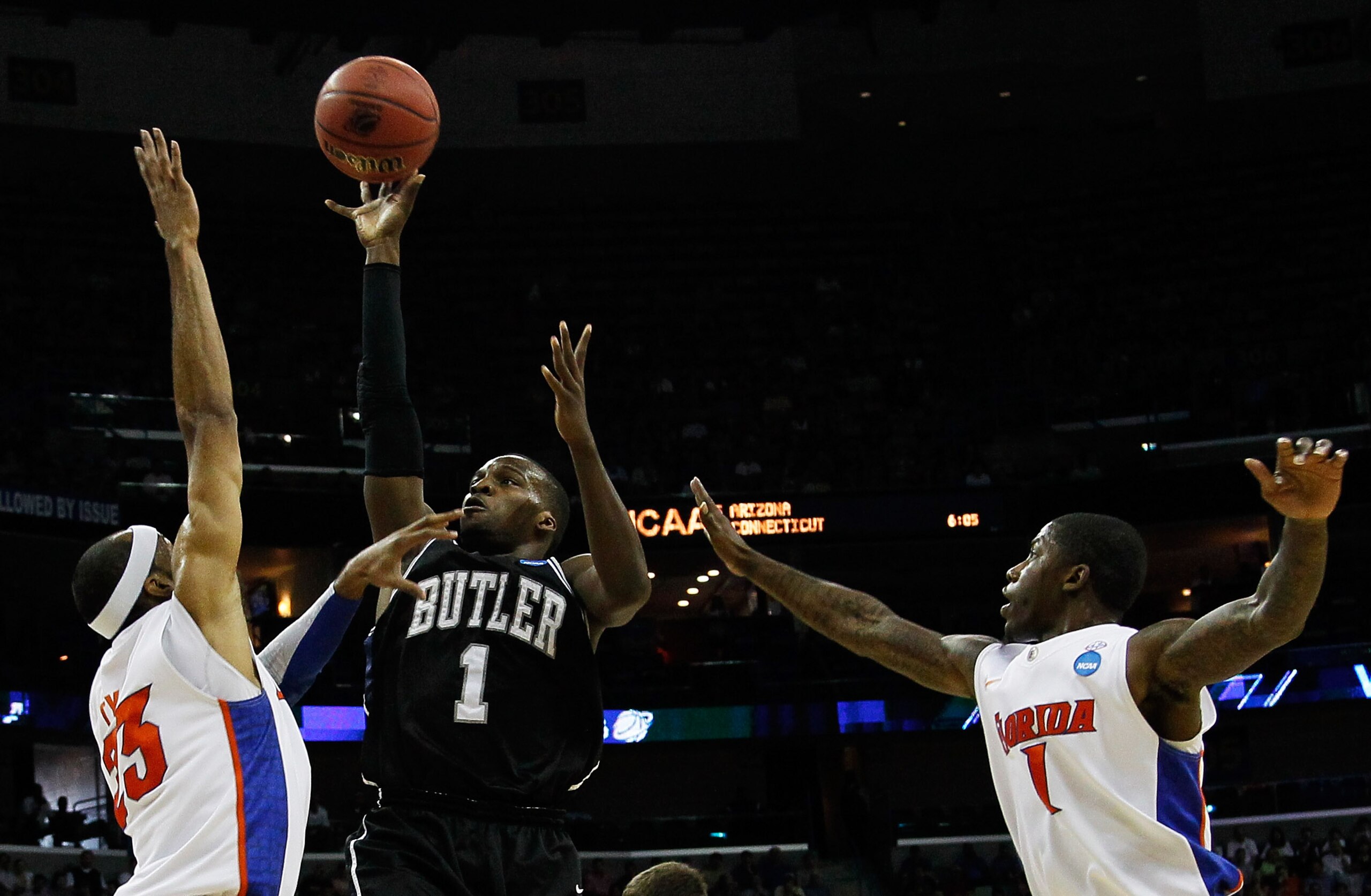 NEW ORLEANS, LA - MARCH 26:  Shelvin Mack #1 of the Butler Bulldogs shoots over Alex Tyus #23 and Kenny Boynton #1 of the Florida Gators in the first half during the Southeast regional final of the 2011 NCAA men's basketball tournament at New Orleans Aren